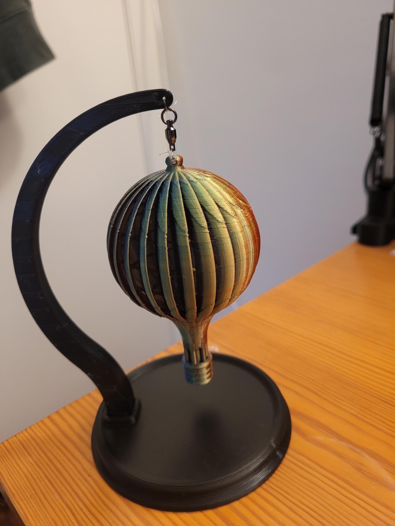 Wind Spinner Balloon Stand - This is a mini stand. The balloon is 100mm tall, and I scaled the stand to 50%. I guess I should have scaled the stand to ~43%, but I already had to remove the clip from the swivel to get it to fit, so I don't mind having the extra clearance. - 3d model