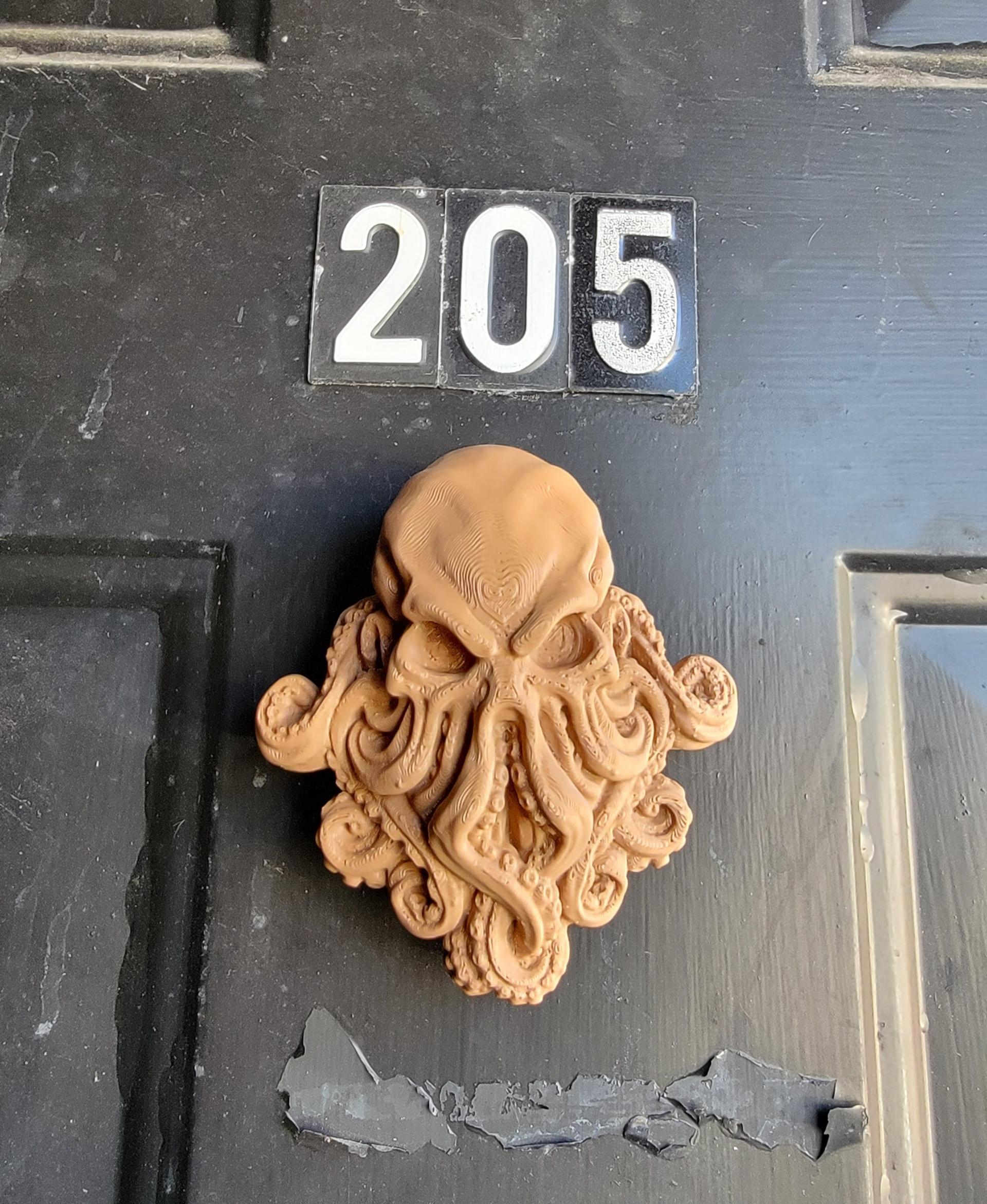 Cthulhu  - Used a magnet and some Velcro tape to make it easily removable. I'm leaving it as a fridge magnet. This would probably be stolen off my front door, which apparently has metal through it. - 3d model