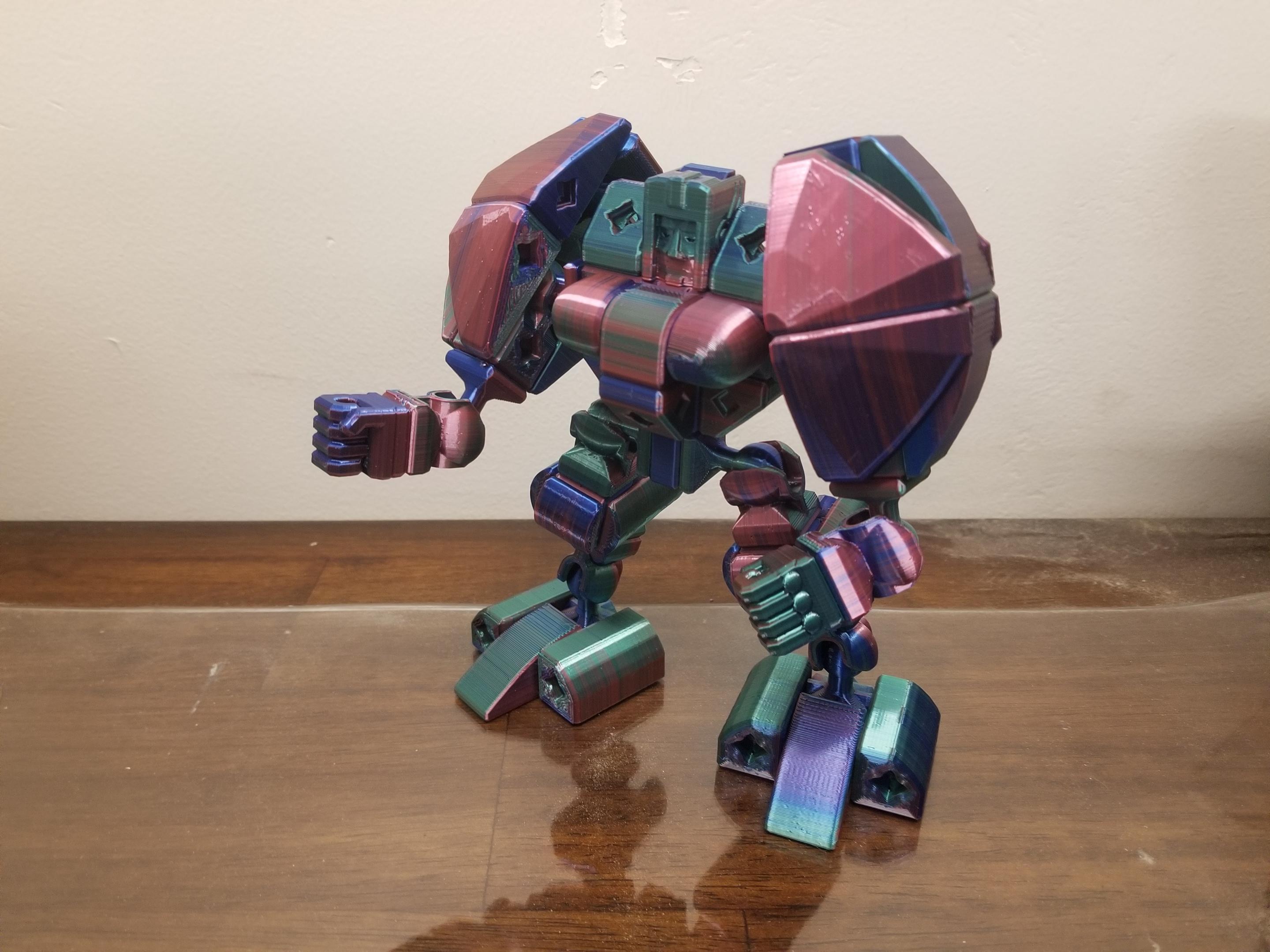 PrintABlok:Battlemecha Frame with basic pilot Articulated KitBash Model - I changed the frame to give it back swept feet and used Prettifier bloks to build out the shoulders and bevel blocks to build up the front and the back.
I call this one "Chonky boi". I open to other suggestions. - 3d model