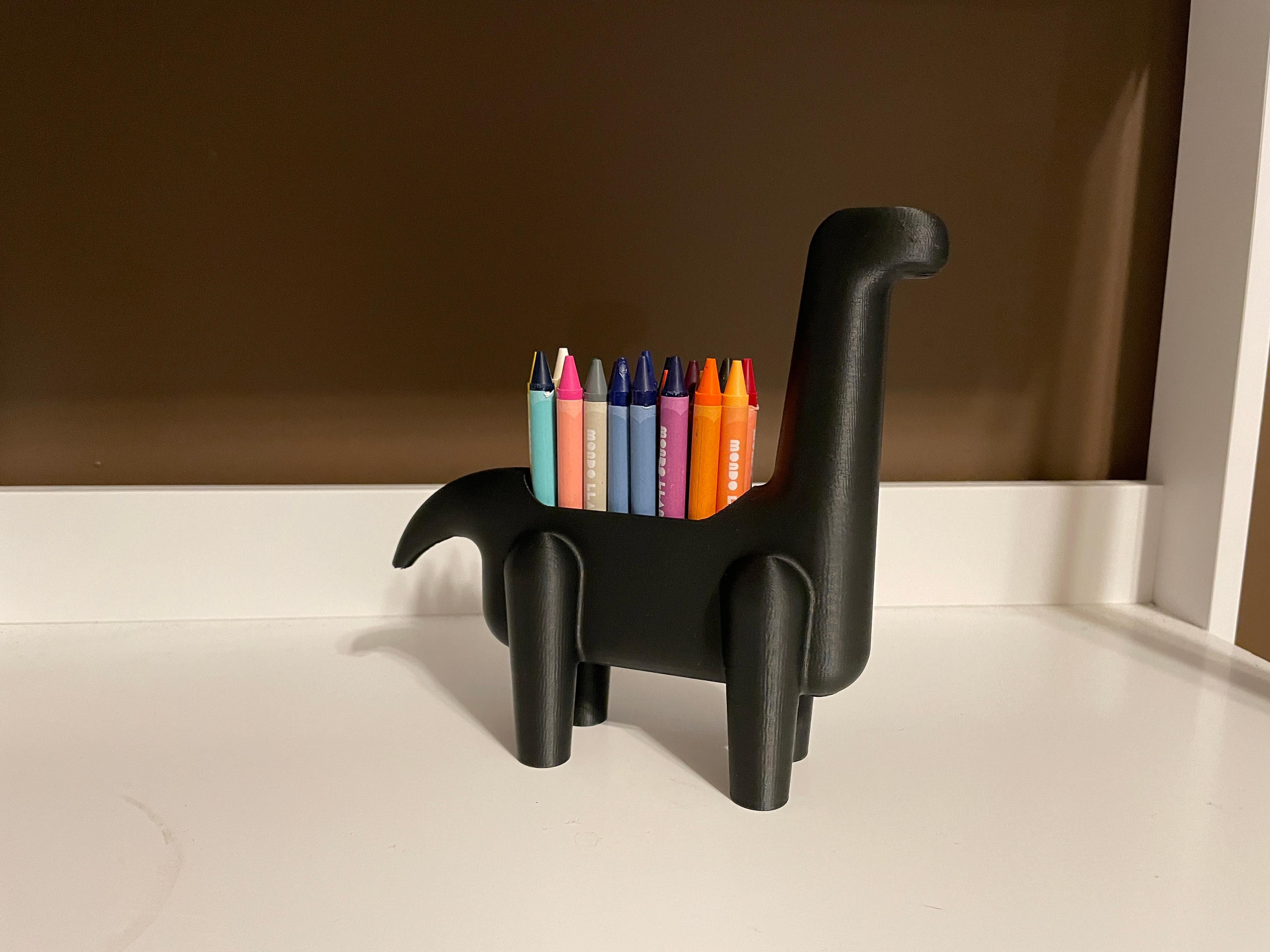 Crayon-o-saur - Crayon-o-saur sitting on a desk printed in matte black pla - 3d model