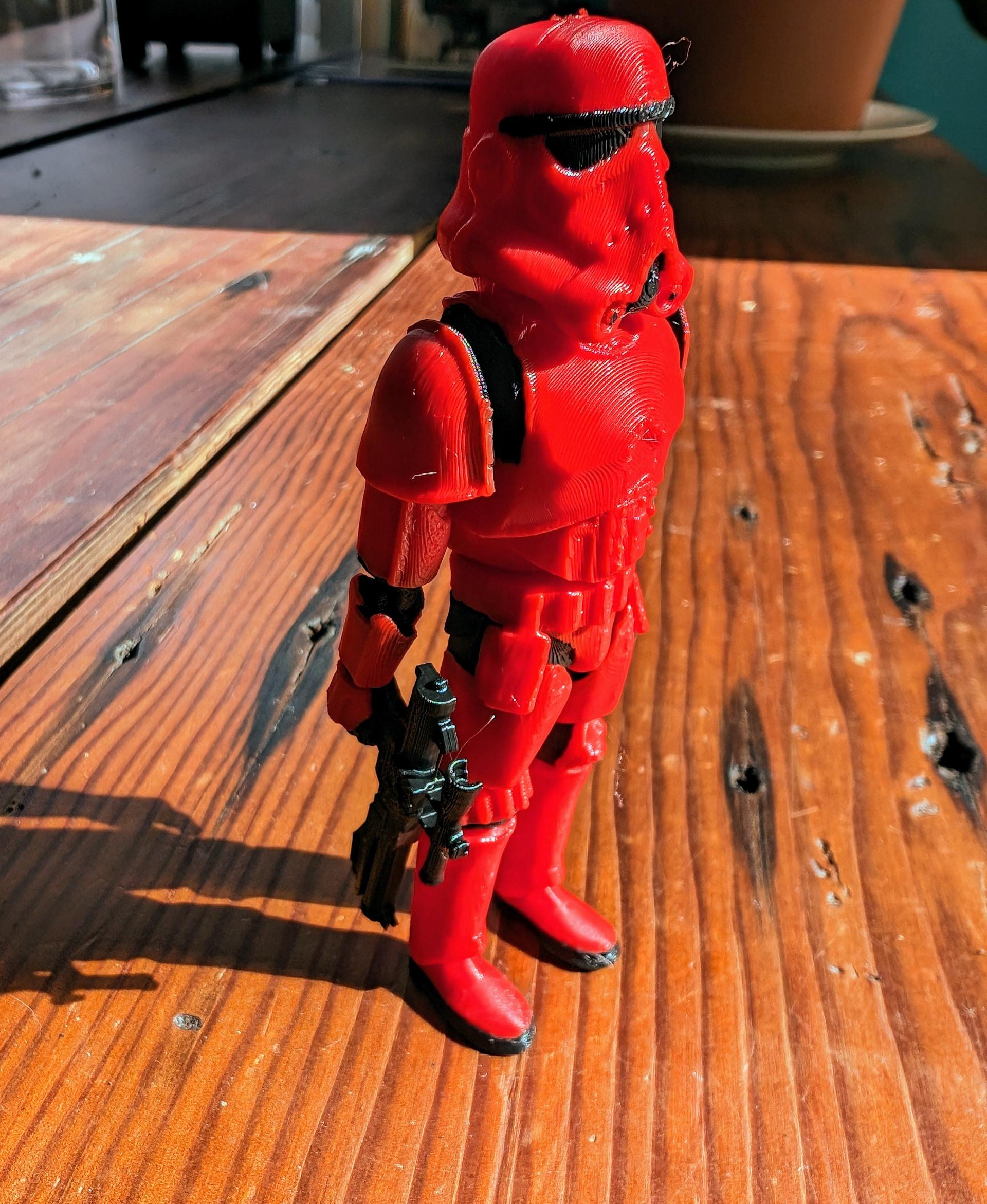 Flexi Print-in-Place Stormtrooper - Scaled to 50% and used the blaster as a negative part in Bambu Studio to hold the blaster (scaled to 48%) securely. Printed great on X1 Carbon with 0.4mm nozzle at 0.16mm layers  Used red for Christmas tree ornaments.  - 3d model