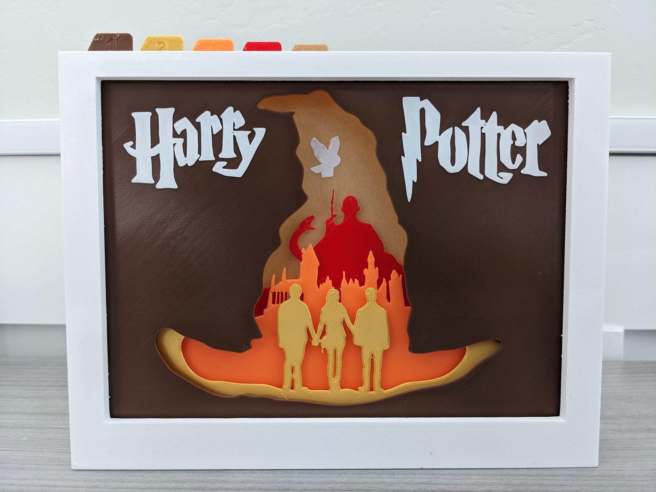 Harry Potter Shadow Box (A) - I combined the 5/6 plates to combine them together which allowed me to use this in the 5 plate display.

Made with:
monoprice white pla
sunlu silk gold pla
monoprice orange pla
overture red pla - 3d model