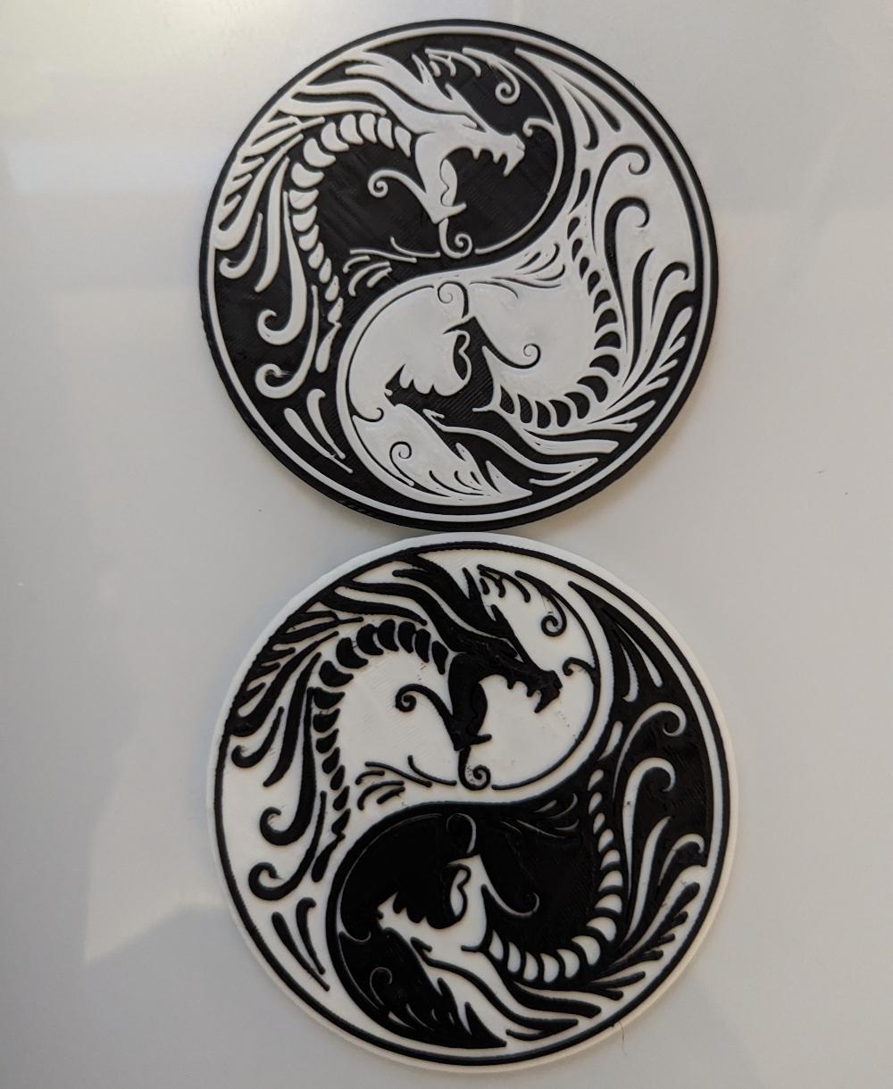 Year of the Dragon Yin Yang - Shrunk the model by 50% on x and y which made them perfectly coaster sized, but mostly did that because I was short on both black and white filament. 
I also used the Command M600 rather than M25 now that my printer supports that one.
(The whole story of that is in the comments of the models post) - 3d model