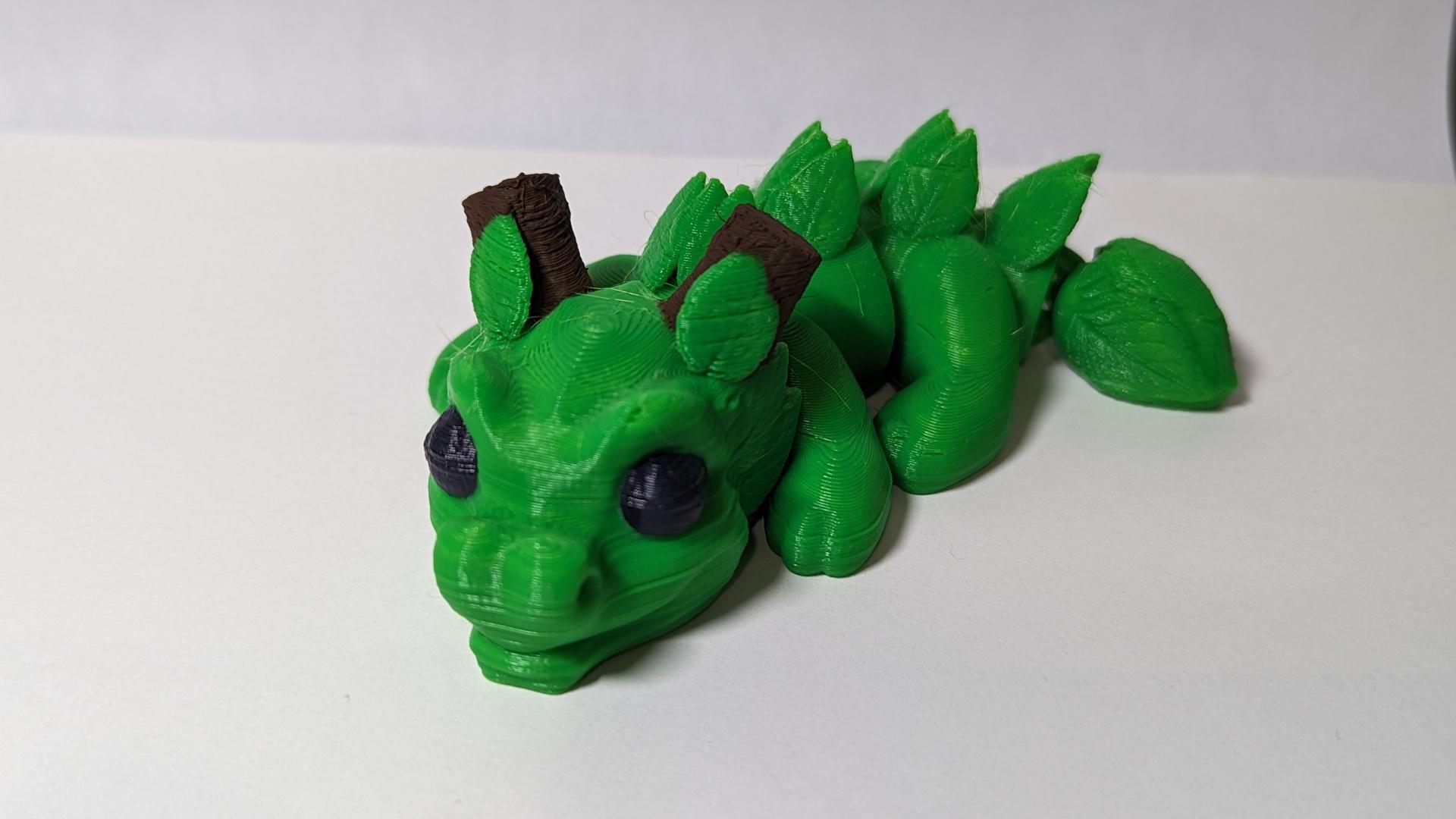 Sprout, Baby Wood Dragon - Articulated Dragon Snap-Flex Fidget (Medium Joints) - Printed with Green CCTree filament at 0.2 layer height. Painted eyes and horns with acrylic paint. Great model!!! - 3d model