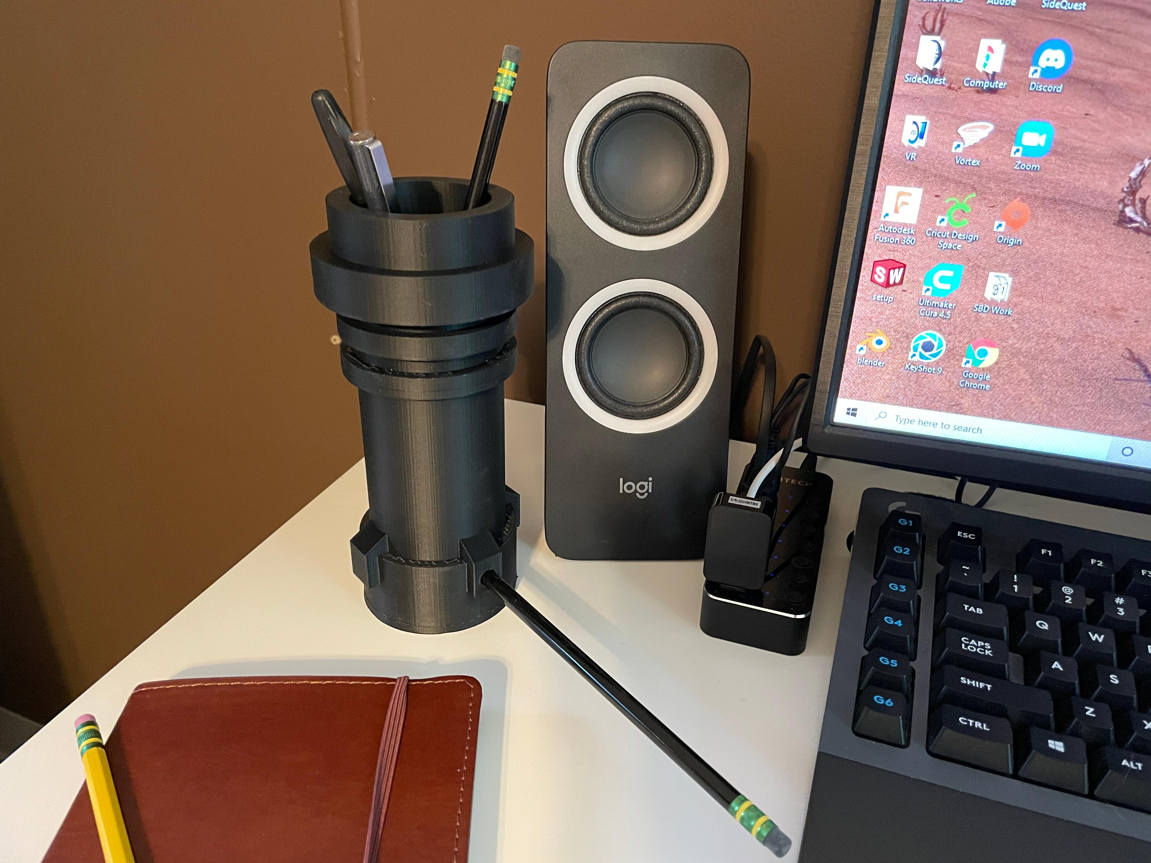 Block Lightsaber Desk Organizer - Printed in matte black PLA on a desk with the pencil sharpener in use - 3d model