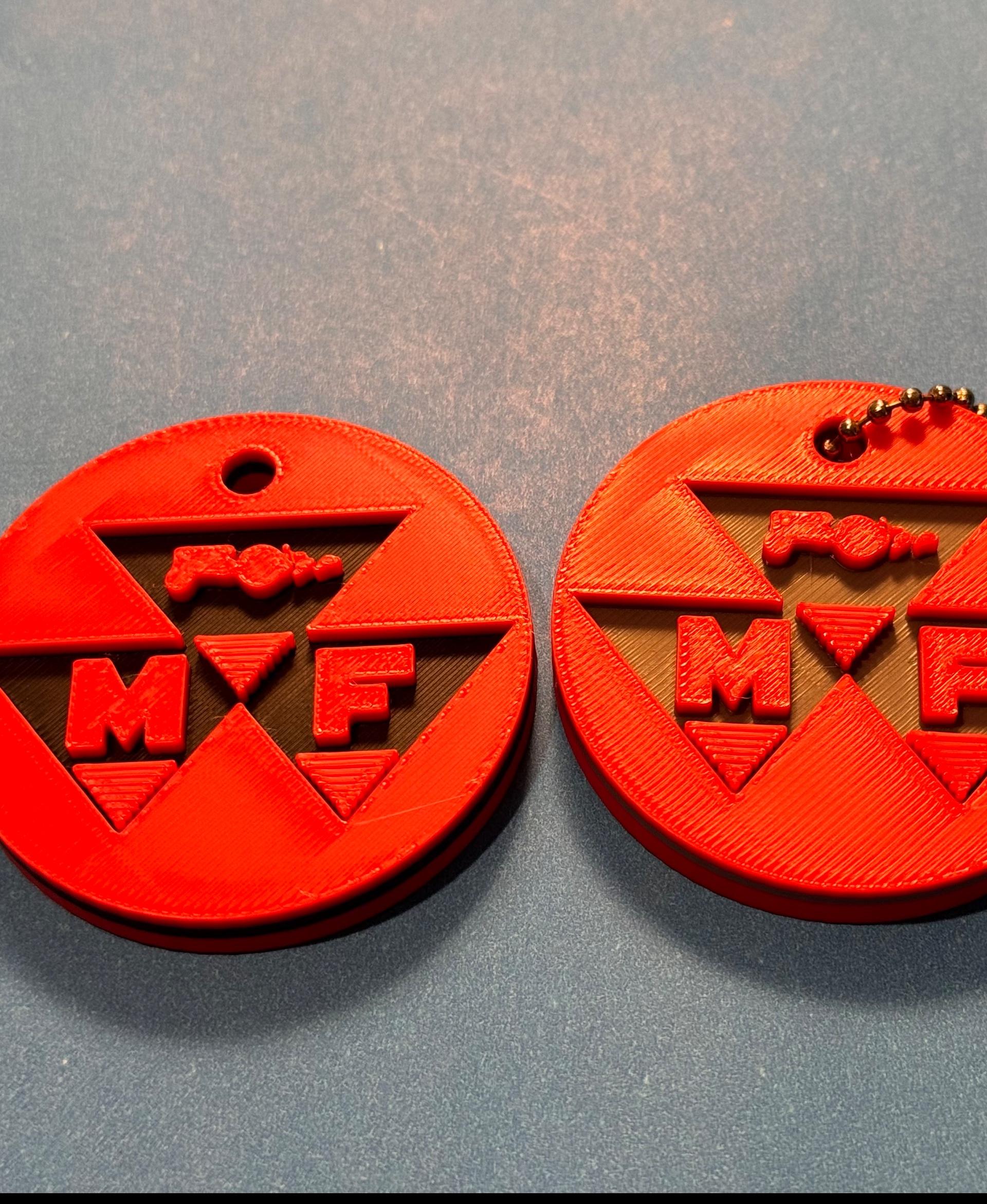 Massey Ferguson keychain - Printed perfectly on my X1C with the layer change recommendations. Great size for keeping track of my tractor keys. Did one in Black and the other in grey backgrounds.  - 3d model