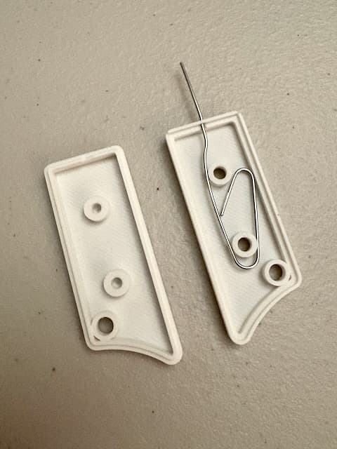 Awesome idea—exactly what I was looking for! Had a half-unfolded paperclip floating around my desk for those random device reset buttons, and I knew there had to be a print for this.
My Knipex cutters worked well for separating the pieces and trimming off the tab. I also cut a little notch out of the non-paperclip-holding side to make space for the paperclip where the pieces fit together, otherwise they wouldn't sit flush with each other.
M3 x 5mm screws worked fine. I had an M2.5 screw that seemed like it might also have fit, had that been my only choice.