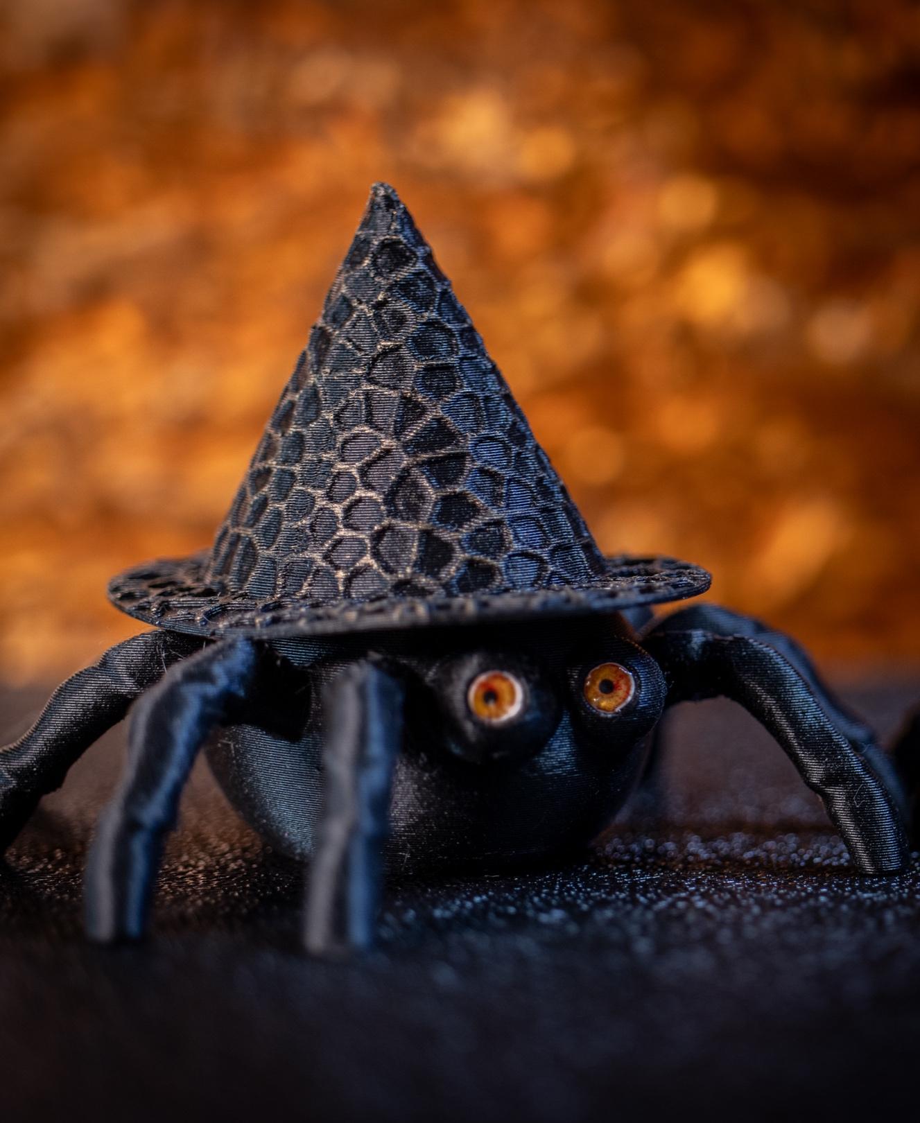 Spider Pot Witch's Hat - Thank you for such a fun design! I resized them to 3 inches, then printed the Spider Pot & Hat using Duramic Matte Black PLA. Then used some gold colored wax on my finger to rub on the high parts of his hat. Printed teeny eyes w/laser printer, then paper punched them out. Glued the eyes in w/3D clear craft glue. I made another one w/blue eyes. :-) Love them! Thanks so much. - 3d model