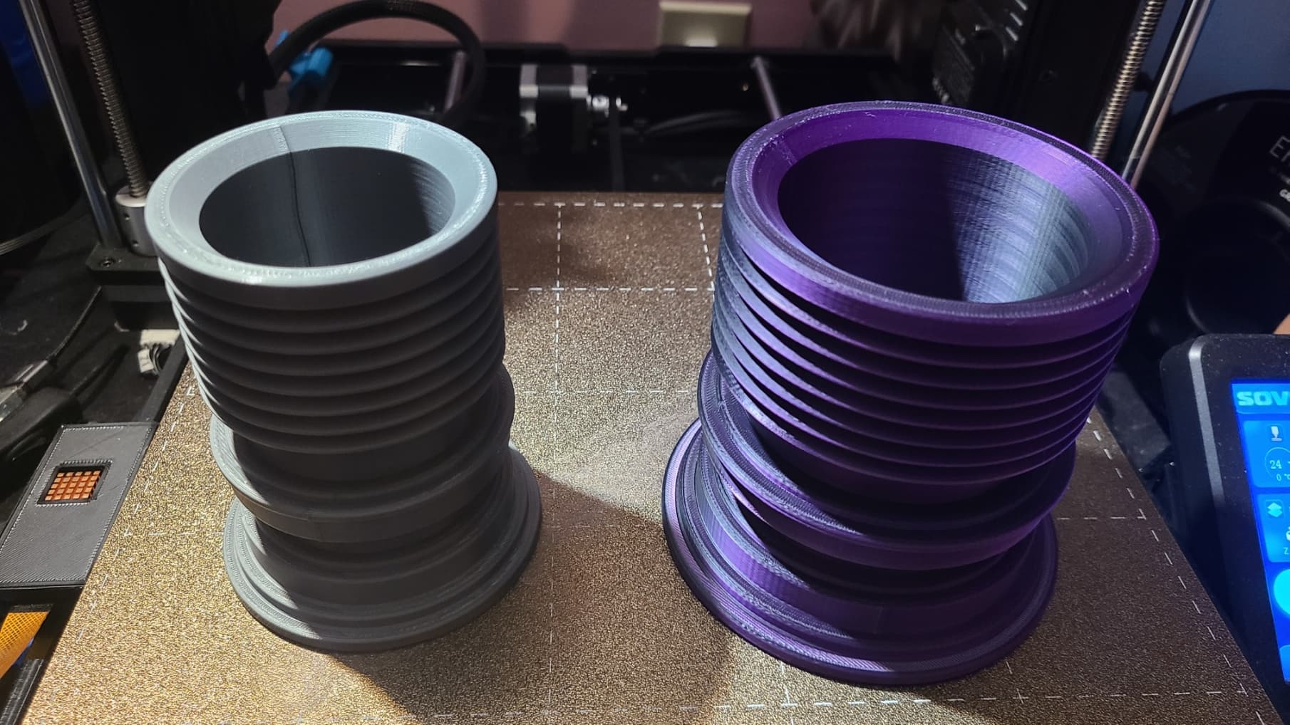Original on left, printed with Polymaker Polylite Grey PLA on a Sovol SV06.
Wife wanted a larger one for storing crochet hooks, etc., so scaled X&Y to 133%; Printed with
Eryone Black and Purple Silk PLA on a Sovol SV06 Plus.