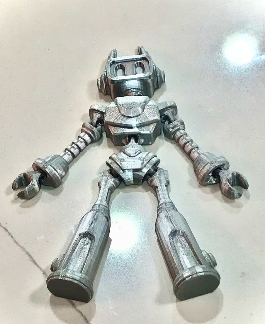 This robot is amazing! ZIPPY! I am new to 3d printing but am learning quickly that it is all about good files. I normally would slow down the first layer in the slicer software but forgot. My first attempt the right hand did not adhere. Then I ran it again but manually turned down the speed to 50%. Worked like a champ. I had also just ordered this silver PLA and loving the look, expecially for this robot. Really great file. The text on the back turned out well too and I know what a pain negative space text can be. Again, this file gets a 5 out of 5 from me!