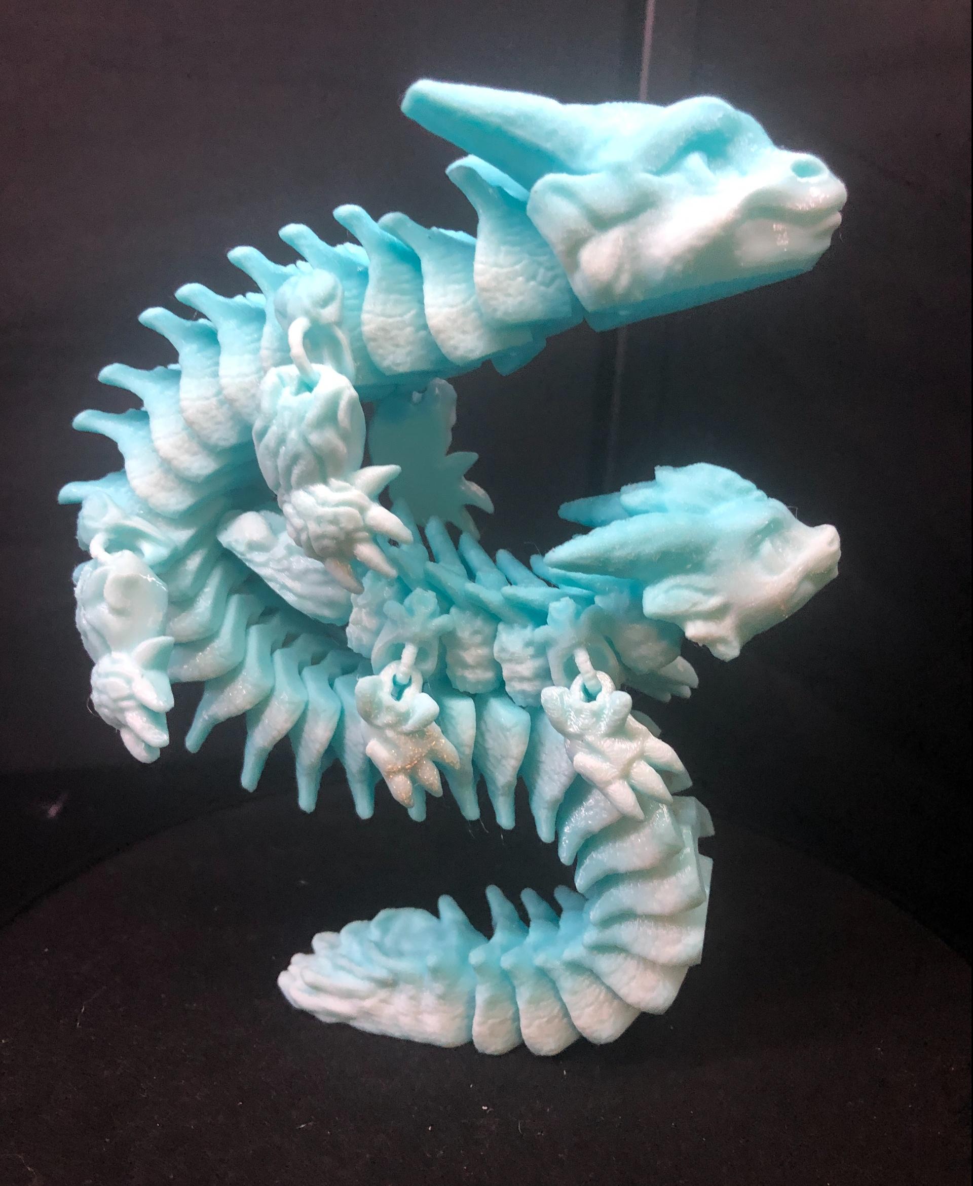 Cold Spell, Winter Dragon - Articulated Dragon Snap-Flex Fidget (Medium Tightness Joints) - @Mimetics3d's #Coldsnap and #Coldspell displaying their snappiest #Snapflex moves with a bit of #articulateddragon gymnastics. Printed on Bambulabs A1 using translucent gradient PETG. - 3d model