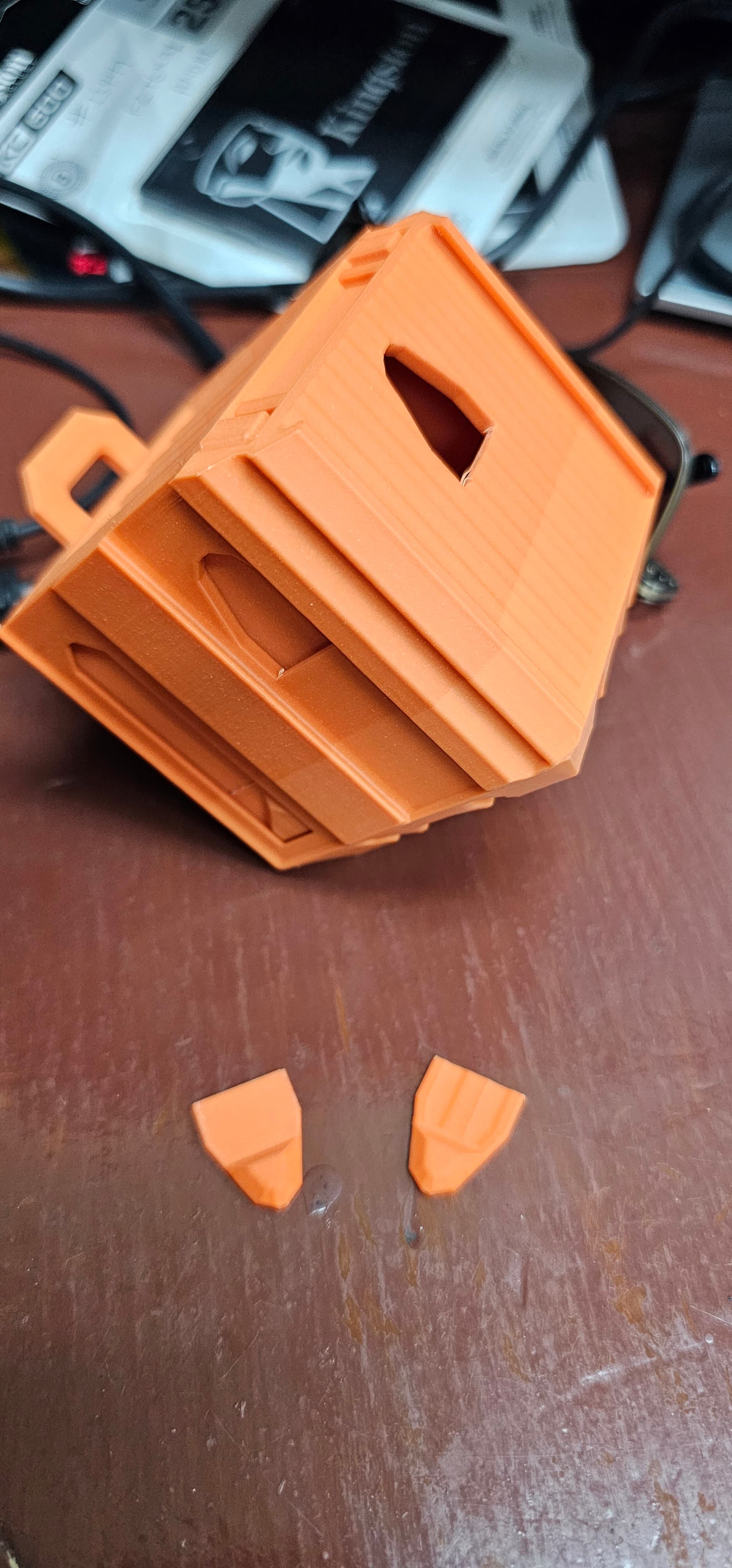 Hey. I wanted to get some feedback. In the picture above the print came out pretty good but these two tabs broke off pretty easily. Is there any way to strengthen them? I was considering printing the container standing at a 45° as shown in the picture, so that the layers aren't aligned with the break point, or maybe switching to a material that's more bendable, like petg. What do you think?