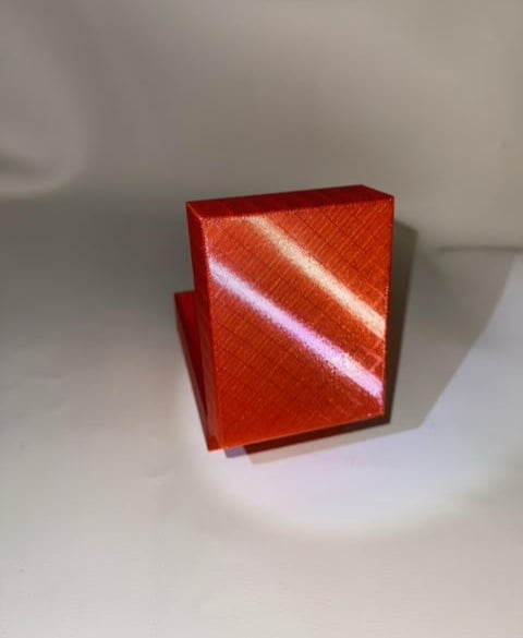 printed in transparent red pla with rainbow sparkles transfered from the build plate!