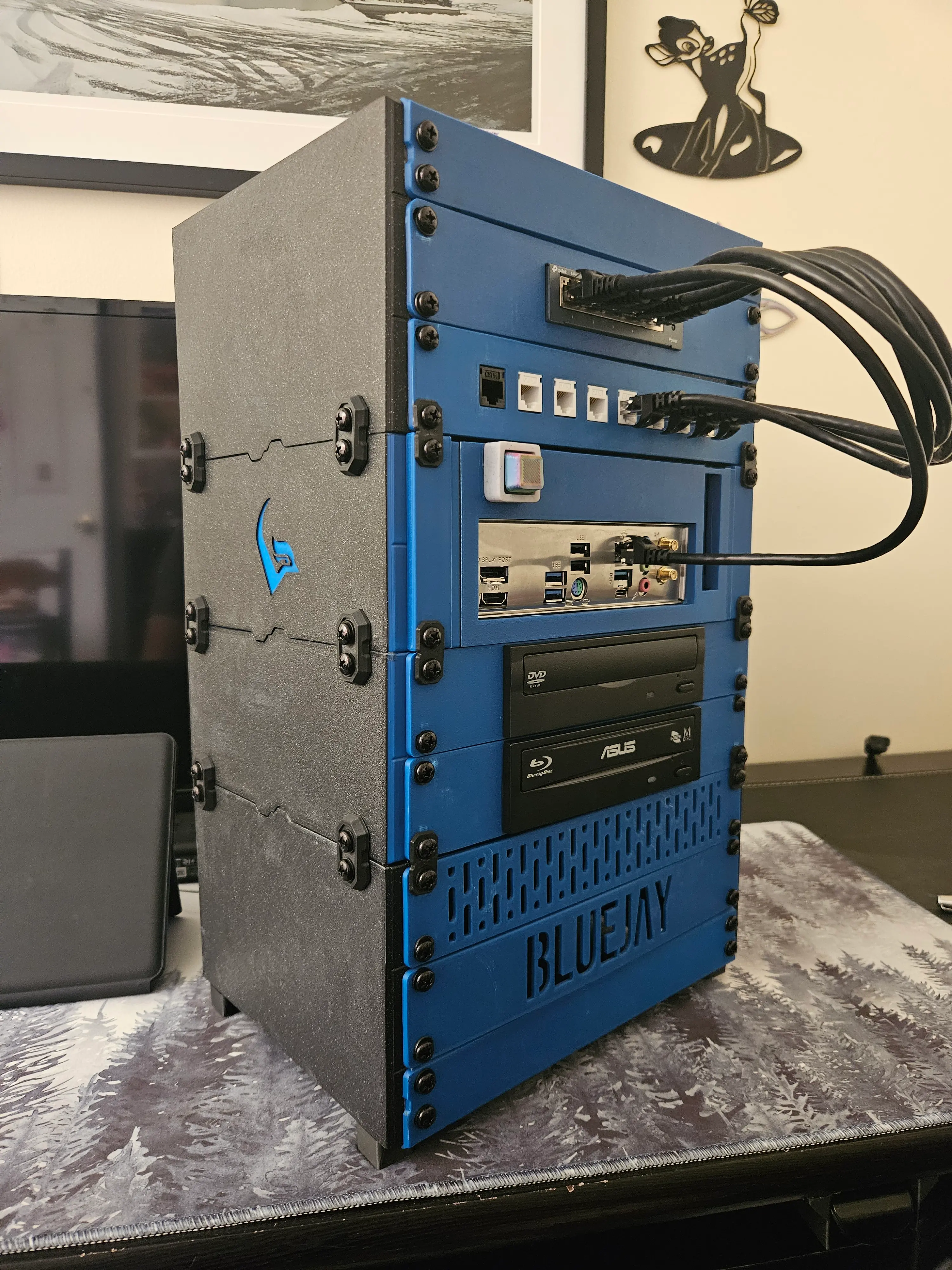 I don't usually upload makes but this is one of my favorite things I've printed. This is an 8U version of the rack with a network switch, patch panel,itx motherboard, dvd drive, blu ray drive, full size ATX psu and 2x4tb drives. My server is called bluejay so I modified some of the blanking plates and side panels to match. Phenomenal design, through and through