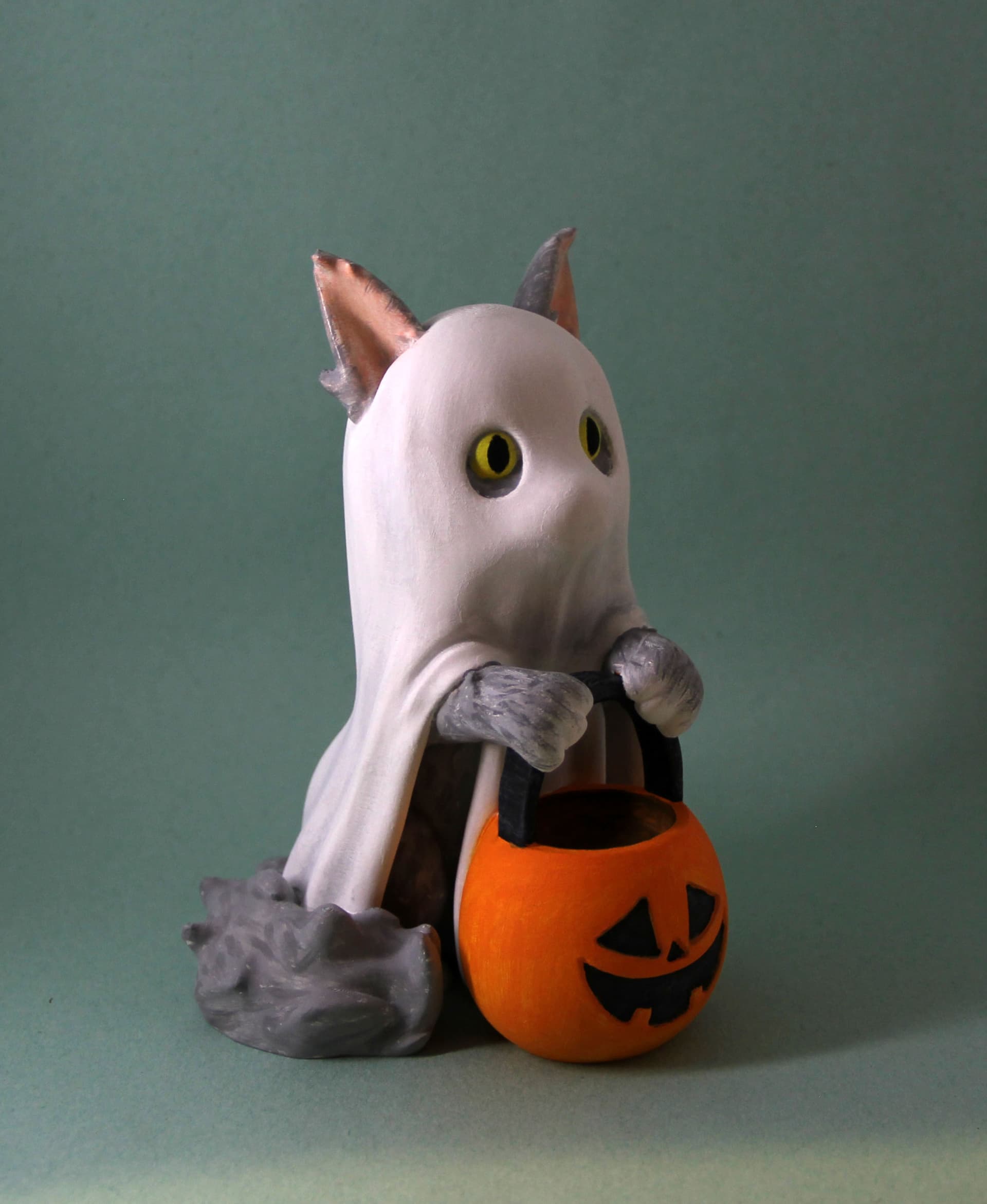 Spooky kitty demands all the treats into his bucket