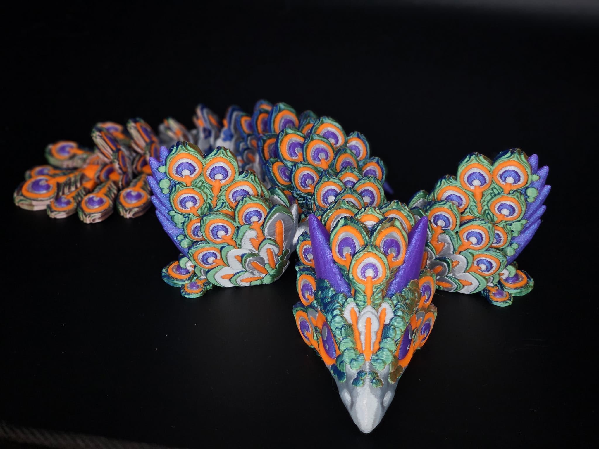 Just an absolute stunning model. I am surprised at the size for it being the baby version. The camera doesn't capture the sheen of the tri-color Inland PLA Silk Mystic Blue Orange Green for the feathers, Cookiecad PLA Silk Witchcraft for the horns, Inlan PLA Pro Orange for the accents and Inland PLA Silk Silver for the beak, body and feather accents
