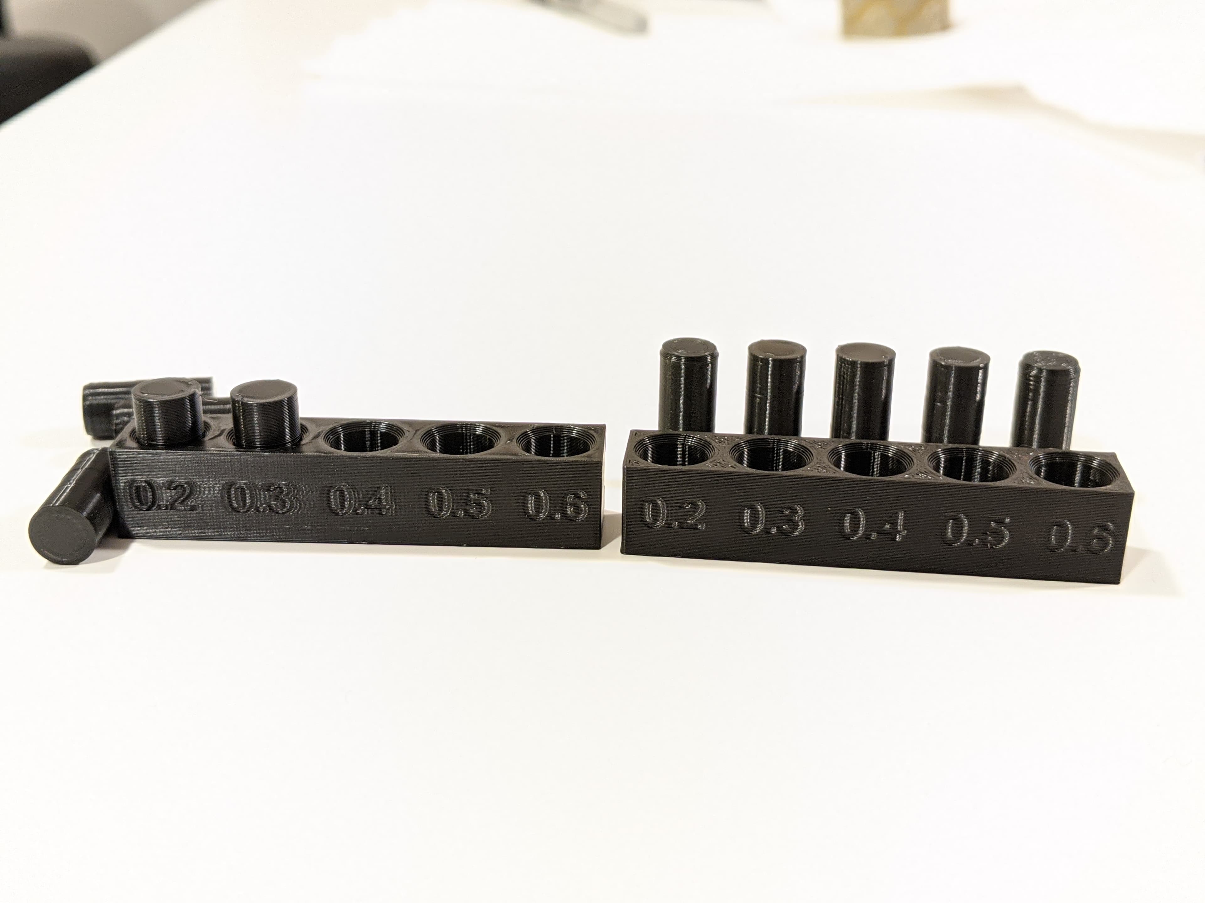 First attempt vs second attempt.
Changed Cura to a lower Flow setting and increased Hole Horizontal Expansion to 0.18 and all pegs came out without issue