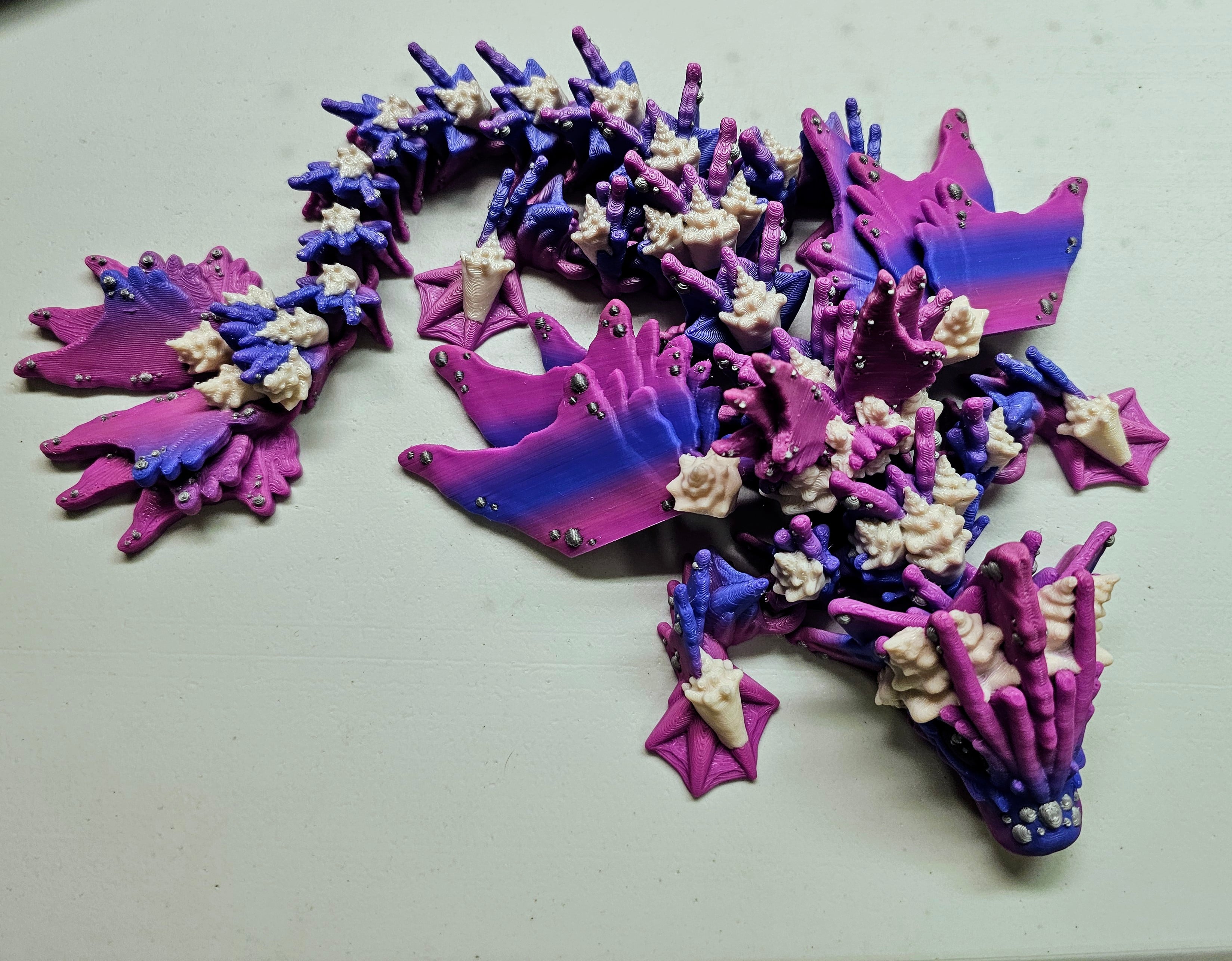 Slowly but surely working my way through the dragon catalog. So much fun!
Blue purple pink gradient body with natural shells and silver bubbles.