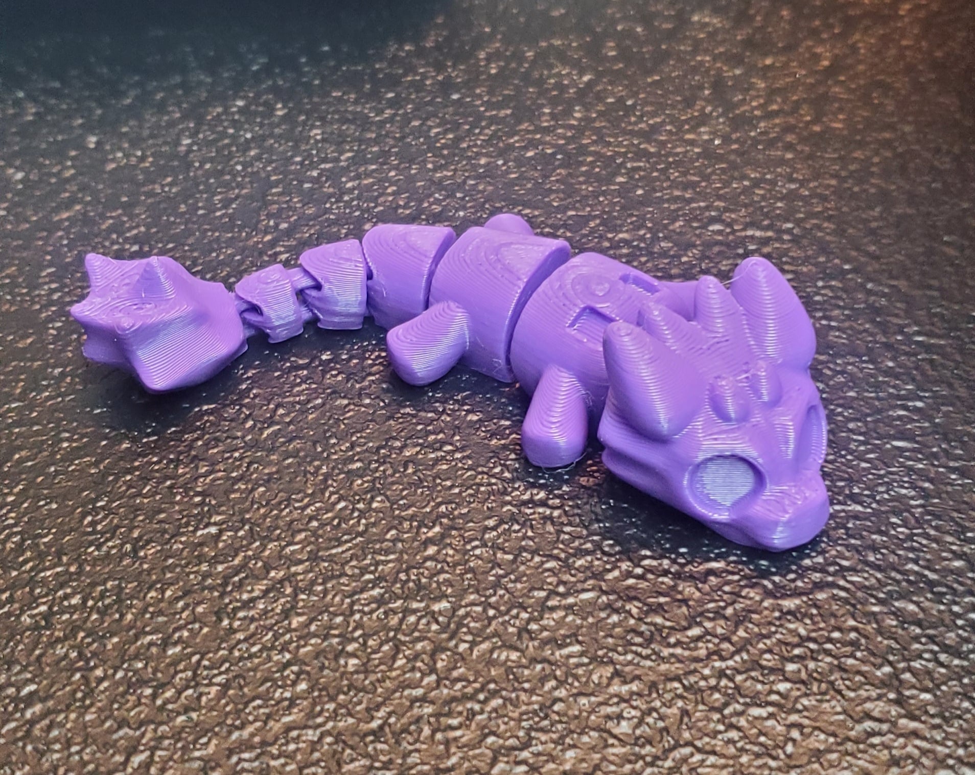 I scaled down the baby dragon by 60%. The body came out perfect but the wings were too small to print right. That's expected for already tiny wings scaled down. Once I learn design I will remix it so the wings are comically large. The body still makes for great minis though.