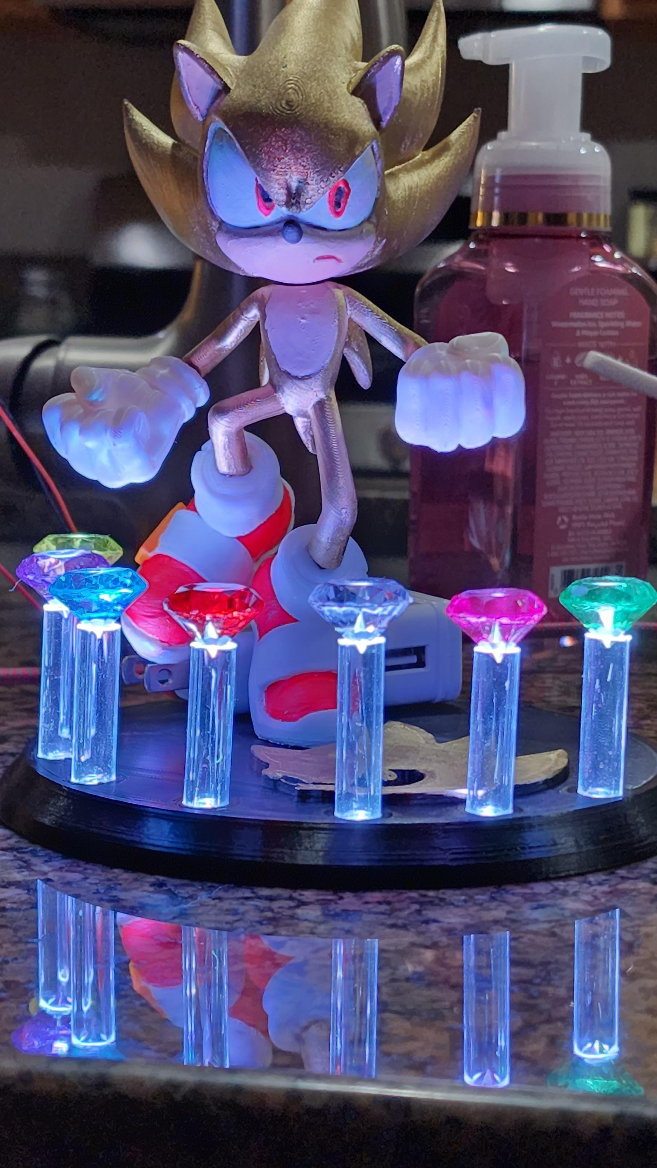 Super Sonic - Sonic the Hedgehog - Fan Art - Modified the base to allow for 7 acrylic tubes to hold "Chaos Emeralds" that could be lit using WS2812 (aka NeoPixel) LEDs with an Arduino. - 3d model