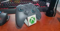 Xbox Controller Holder Round - Printed in white resin with a hand injected transparent green inlay for the logo.

Holds the controller beautifully.