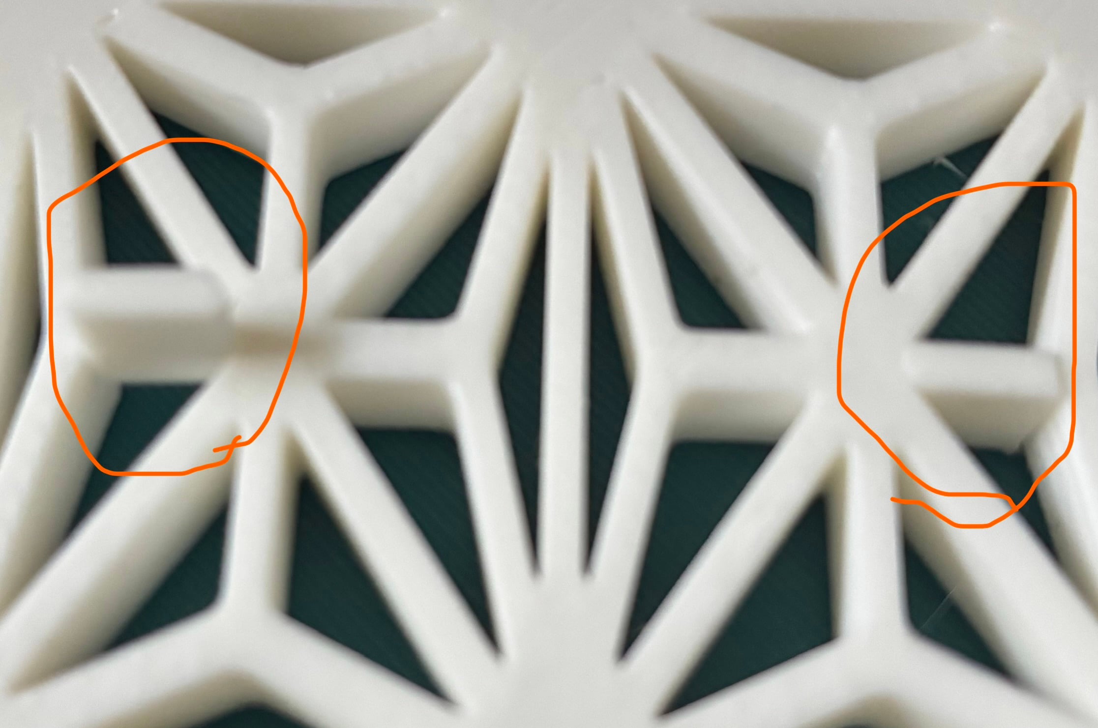 Here's my fix: I cut the design down in Bambu Studio, brought the single line of the design into Tinkercad, duped it as a negative and slid the two design elements together to join them, leaving only the little missing pieces. These press-fitted into position. The image shows both circled in orange with the left one just starting and the right one in position. Almost imperceptible!