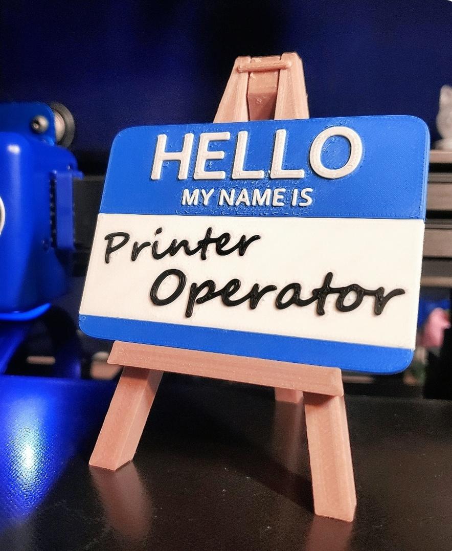 "Printer Operator"  - 'HELLO MY NAME IS Printer Operator' Nametag printed in Sapphire Blue + B & W PolyTerra PLA. - 3d model