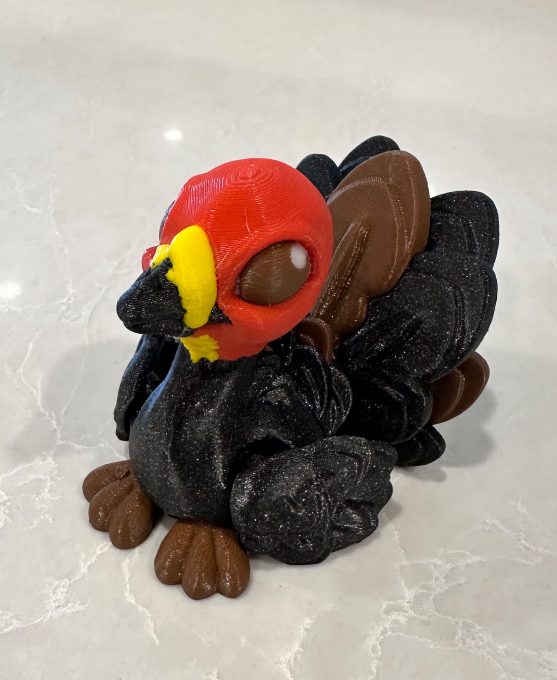 Repainted this a little bit into an Australian Bush Turkey edition. Printed at 75% scale with various filaments:
* Prusament Galaxy Black
* eSun PLA+ brown and yellow
* Generic PLA red and white