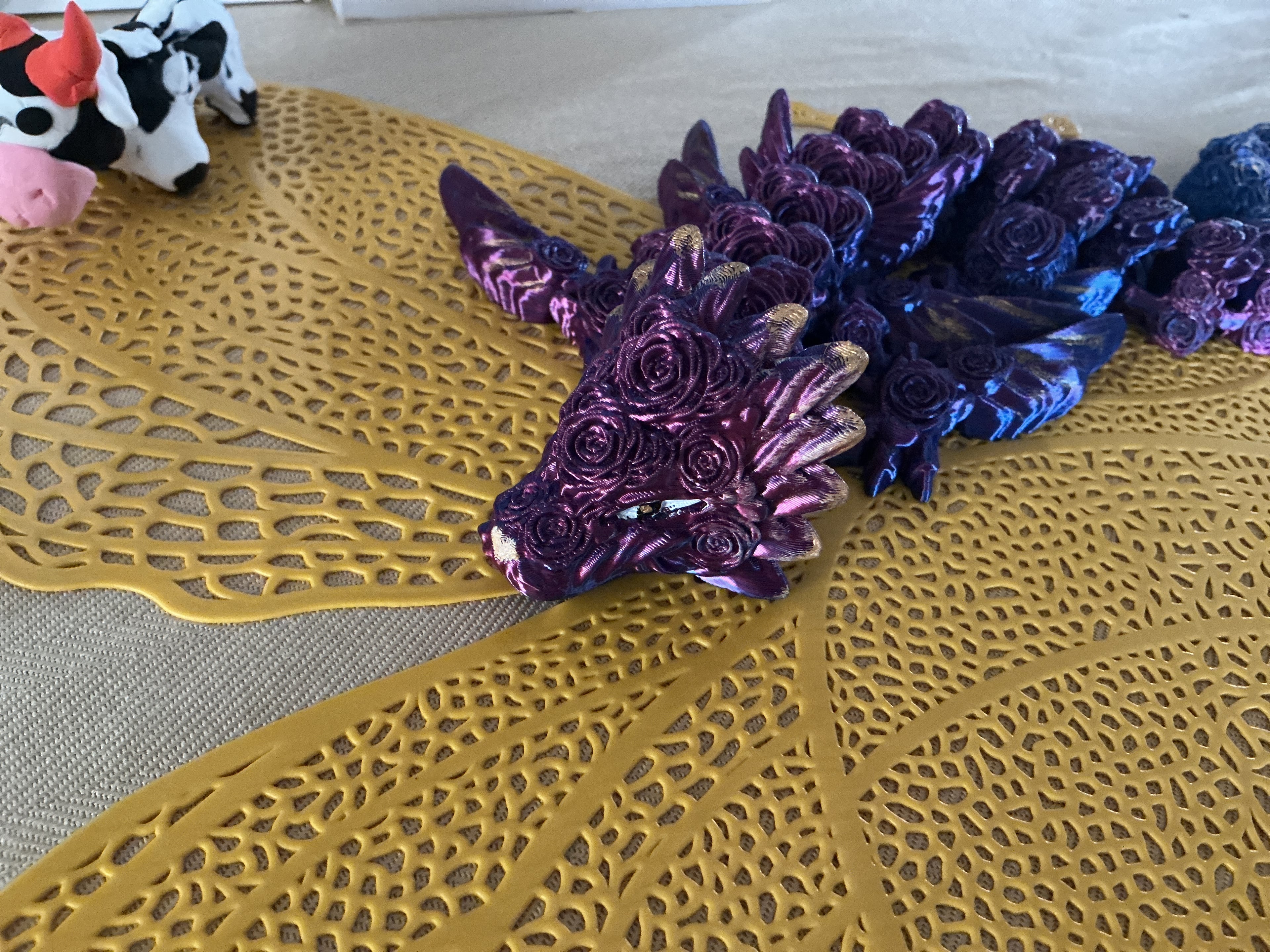 I printed her with pink/blue PLA silk filament
I do NOT have AMS, so I painted her with metallic gold, pure black, and titan white.
She’s really cute though, thanks again cinderwing!
But can you make it so that the dragon’s original scale can size with the a1 mini’s print plate? Just because I went to go get clickers and they didn’t fit into the tail.
There is another picture of her below this one, but that was before the paint.