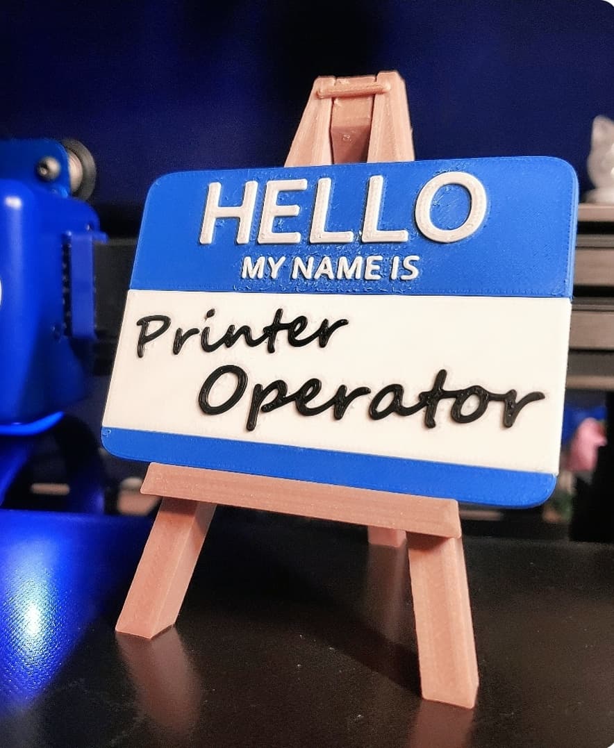 'HELLO MY NAME IS Printer Operator' Nametag printed in Sapphire Blue + B & W PolyTerra PLA.
