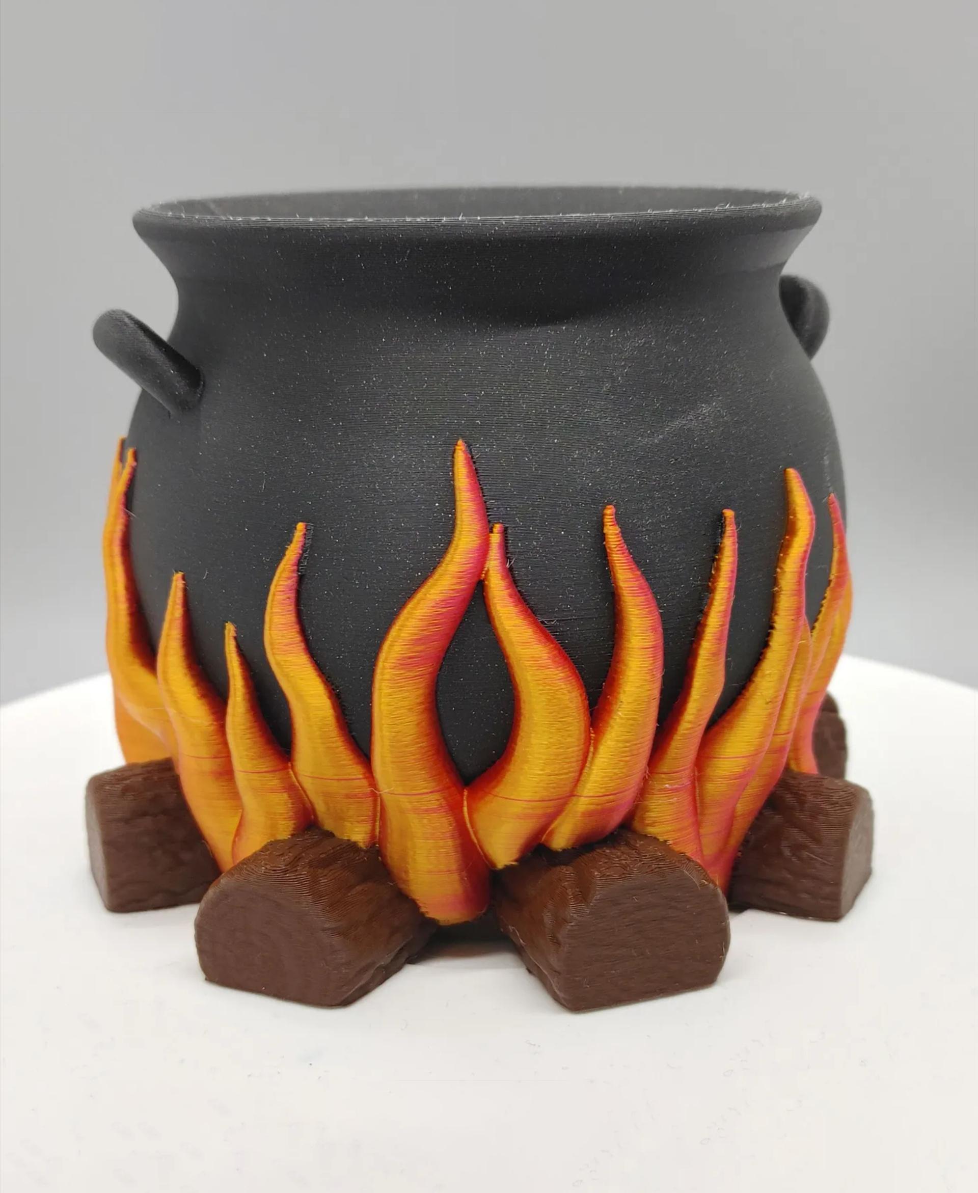 Flaming Cauldron - Love how this turned out! Such a great model. Printed in Printed Solid Soul Black Glitter & Tree Brown PLA and Eryone Dual Color Red & Gold Silk PLA on the Bambu X-1 Carbon using the AMS.
 - 3d model