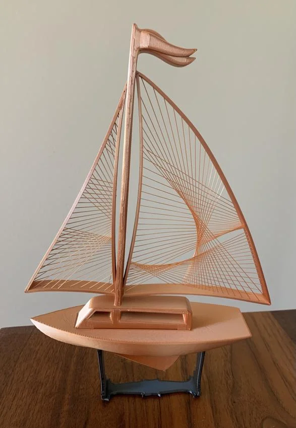 This was awesome to print, thank you! This is a copper-colored filament and the sail strings glisten in the light.