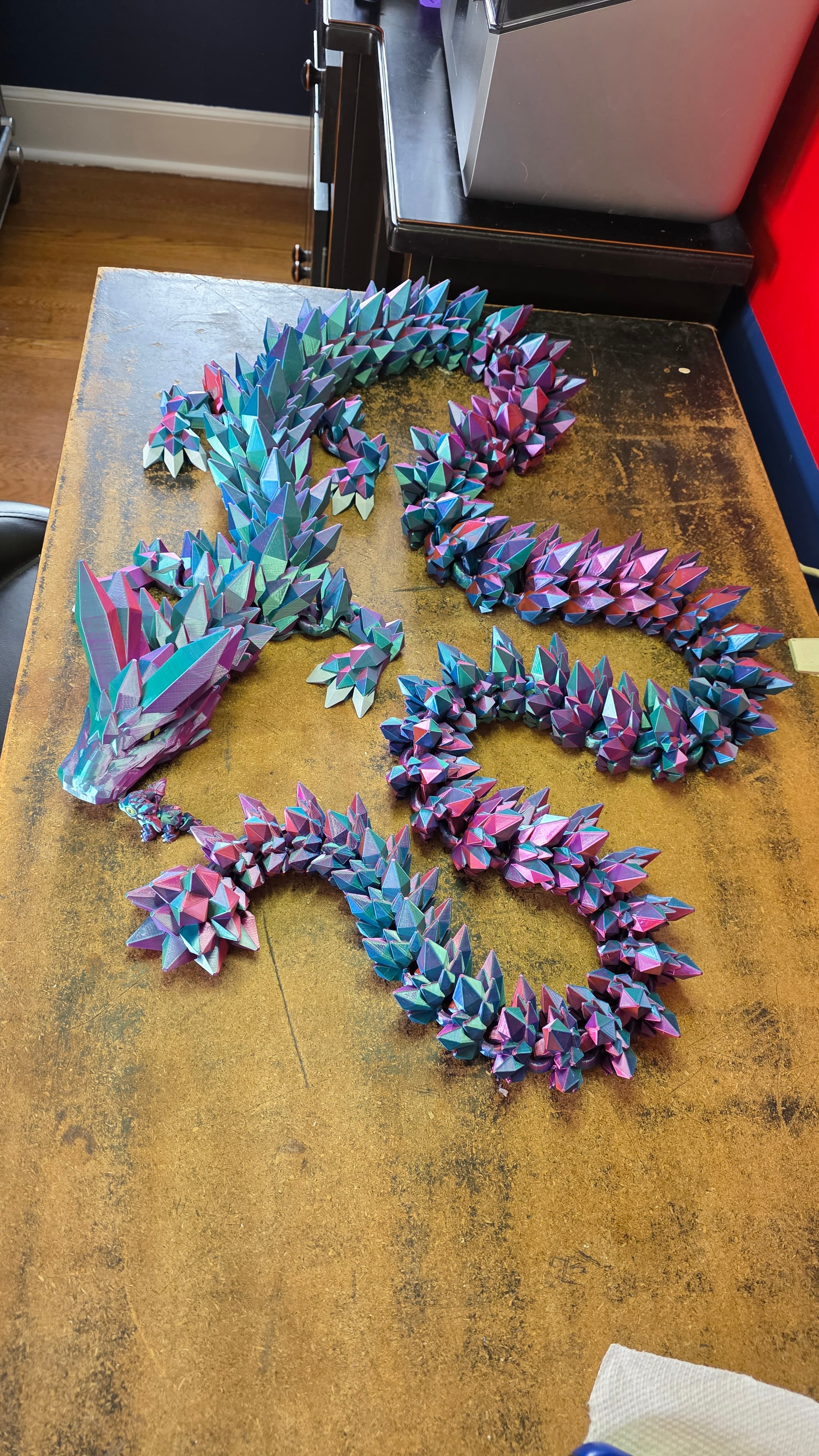 Eryone Aurora Dream quad-color silk PLA on a Creality K1SE. I used the 300% plates, scaled to 70% and printed plates 4-8 twice for a 7-foot Mega. Collective print time appx 125.5hrs, just under 2 spools of filament (with enough to make him a little buddy). Eyes teeth and claws are painted with oil-based acrylic paint pens because with the quad-color filament, the CFS caused too much of a twist in the filament with each retraction causing banding in odd places.