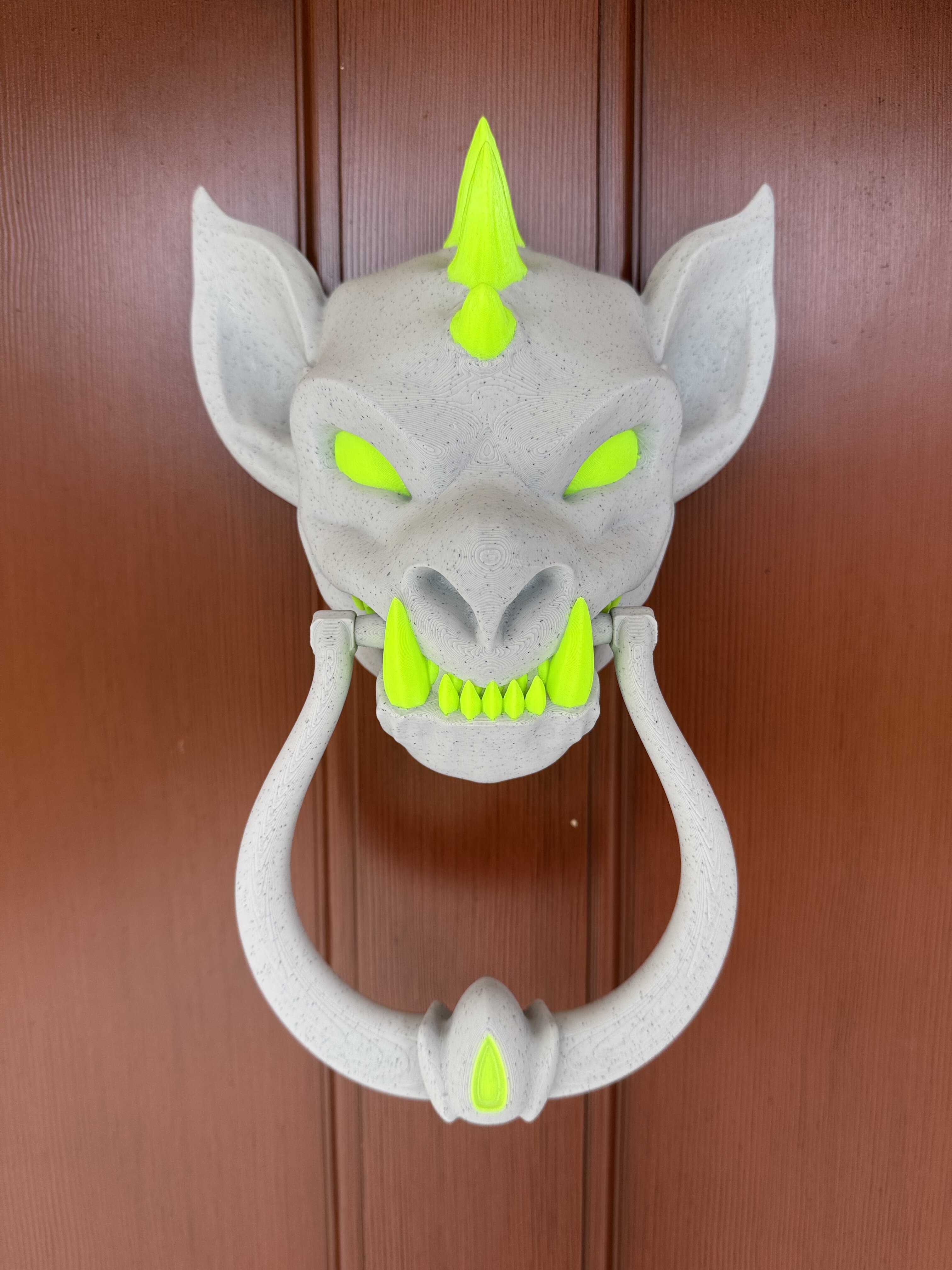 Needed something to add a bit of blacklight glow to my front door, and realized this would be a perfect example. Just wish I'd realized it a bit earlier so I would have had time to print it even larger.
This is the "separate" version, which I thought might hold up a bit better due to layer placement of the knocker.
Painted in PrusaSlicer. Both colors are PrintedSolid Jessie PLA.