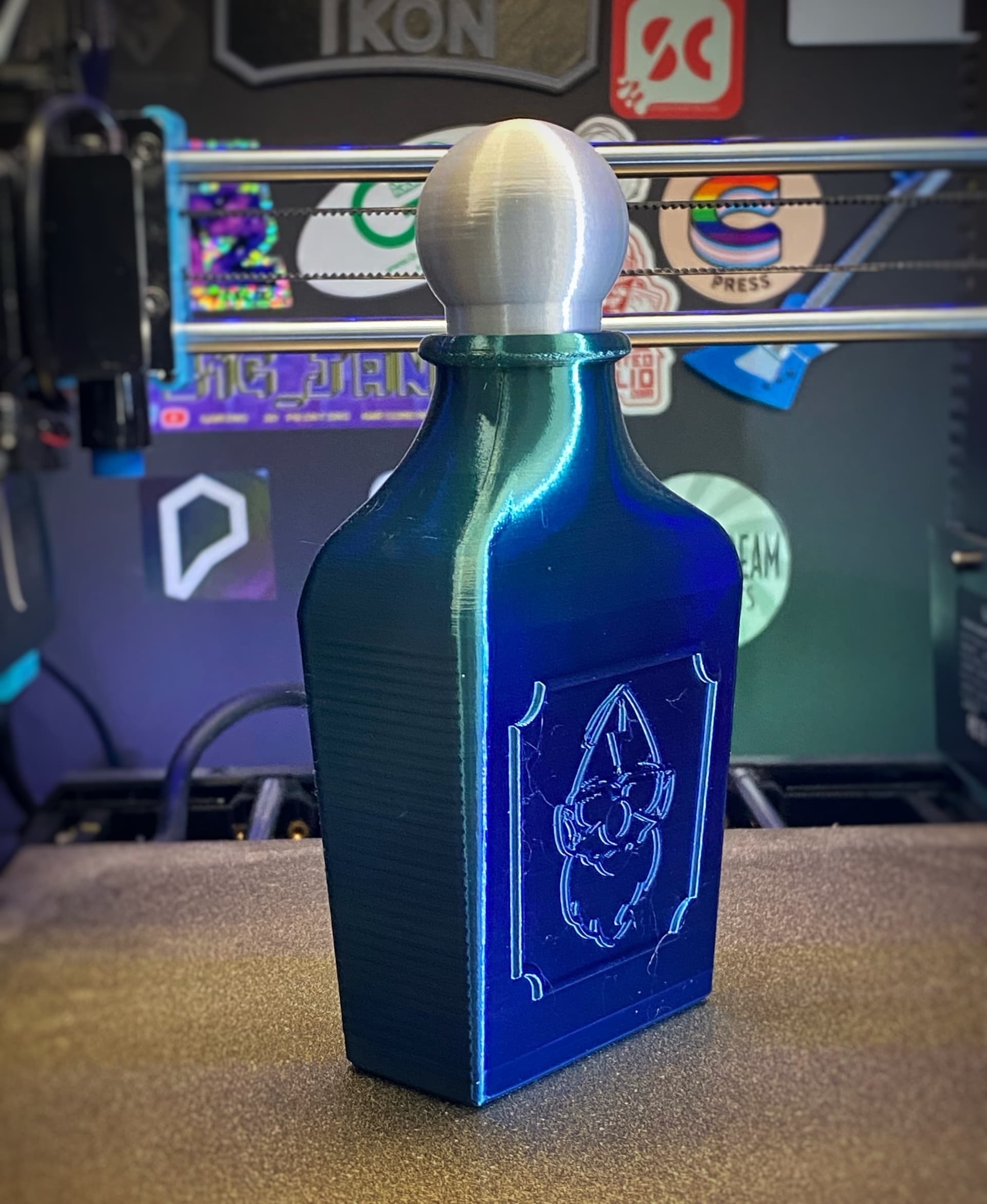 Printed in Printed Solid Import series Blue/Green Gradient Silk PLA for the bottle and MatterHackers build series Silk Silver PLA for the stopper.