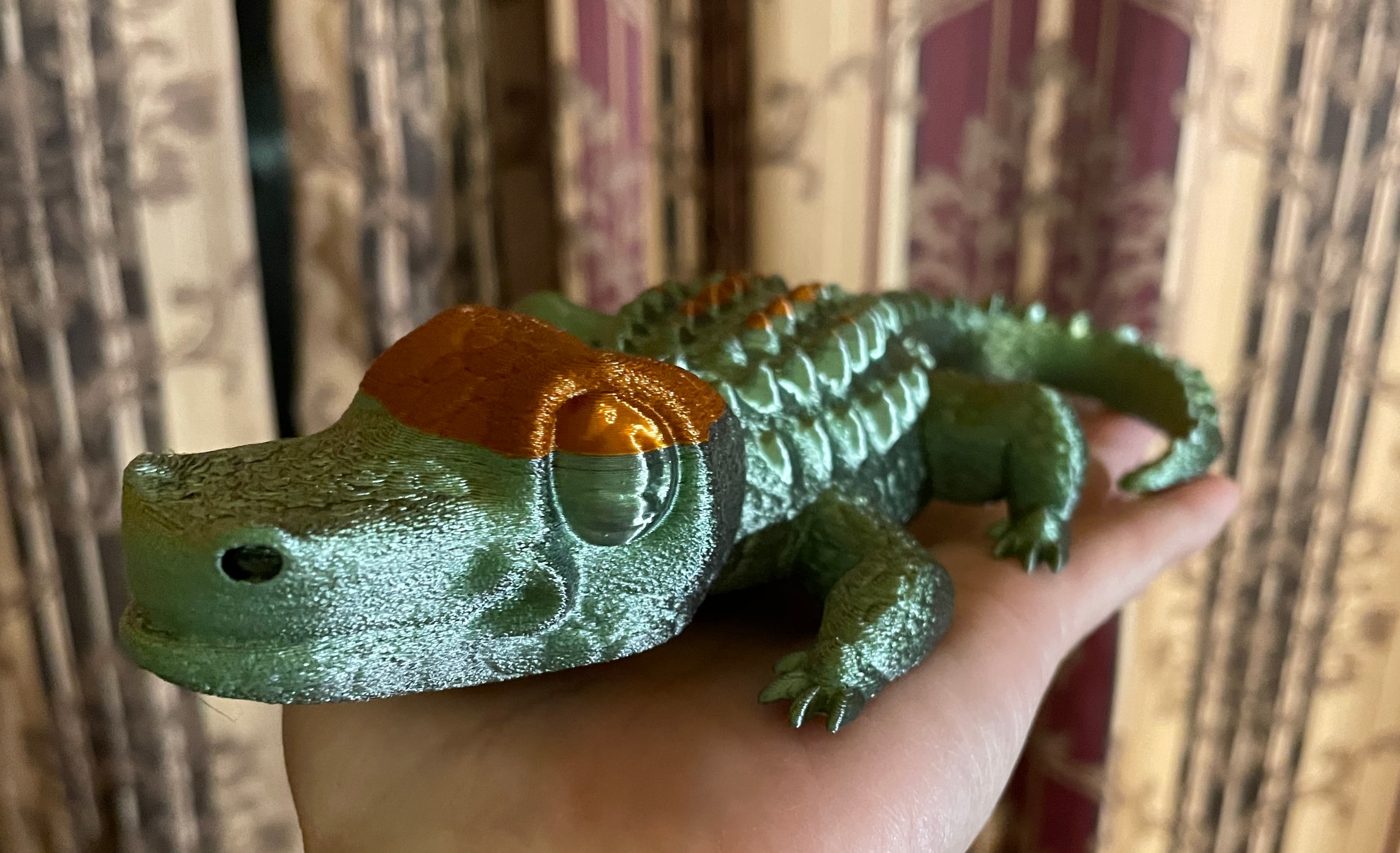 Cute Crocodile Figurine - I call this Crocodile with toupee'. I was printing with a gold, green black filament by ender and ran out just at the top of the head, so used copper lol. Thank you for an awesome print, I also added fuzzy skin it really came out great! - 3d model