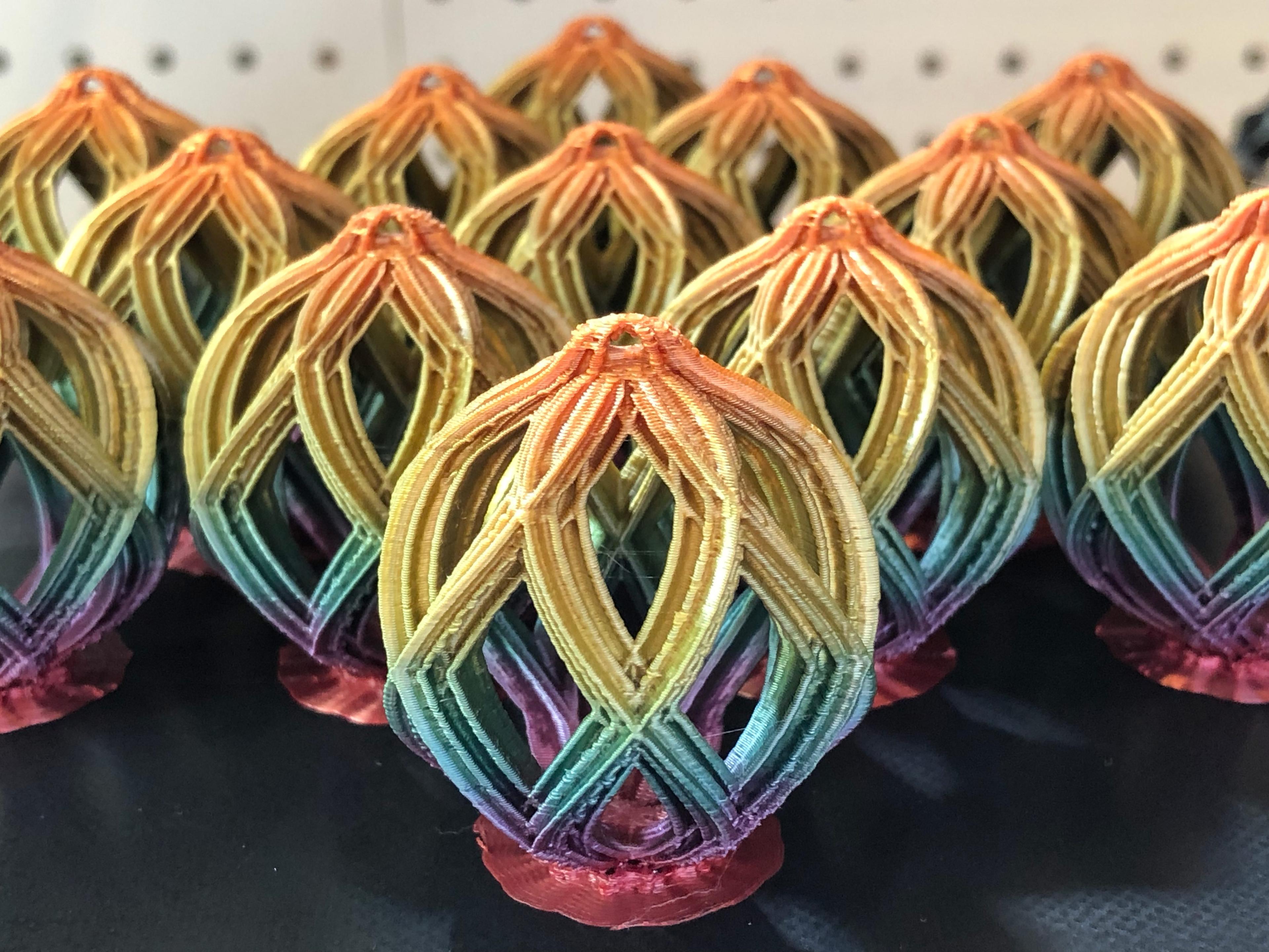 MINI Ornaments - This is version 3.2 of the Christmas Lattice Ball. I simplified the geometry in version 3.2 to make it easier to slice and print multiple at the same time. This allows you to have dramatic color changes using color change PLA (shown is the TTYT3D Quick Change PLA) and it also helps with the model overheating - especially at the very top. This group of 13 ornaments printed in about 17 hours. - 3d model