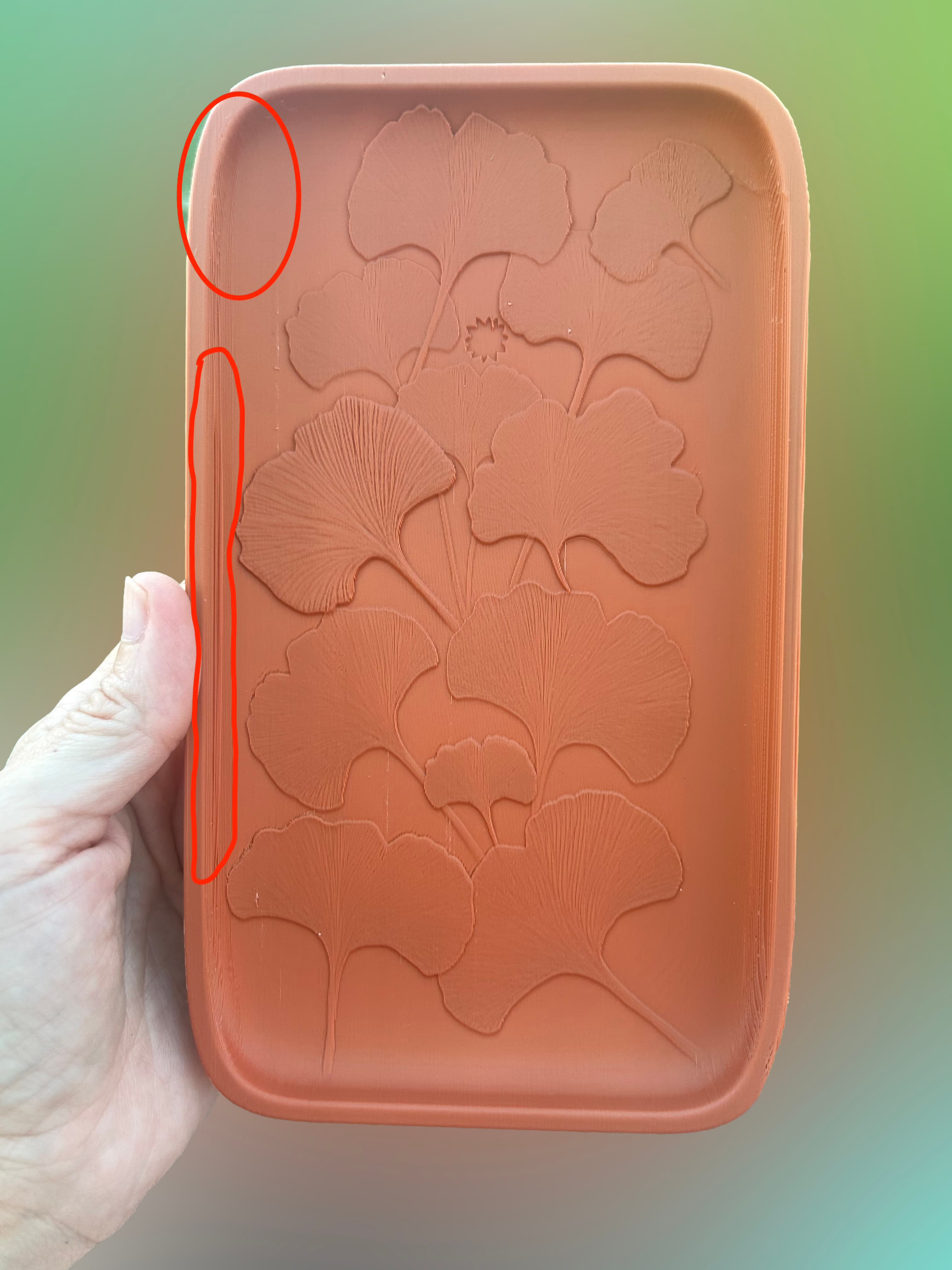 Disappointing Design – ⭐️⭐️ out of 5
The Ginkgo leaf pattern prints nicely, but that’s about the only positive here. This model felt like a waste of filament and time. It prints like an AI-generated design—visually appealing at first glance, but impractical in execution.
I printed it on its side, as the designer recommended in a comment. It’s an illogical and counterintuitive orientation, but I followed their suggestion. The result? Not great. Flipping the model flat helps with structure, but ruins the look of the Ginkgo pattern.
I really loved the idea of the tray, but I wish the designer would focus more on refining functionality and printability, instead of rushing out designs.
Photos speak for themselves.