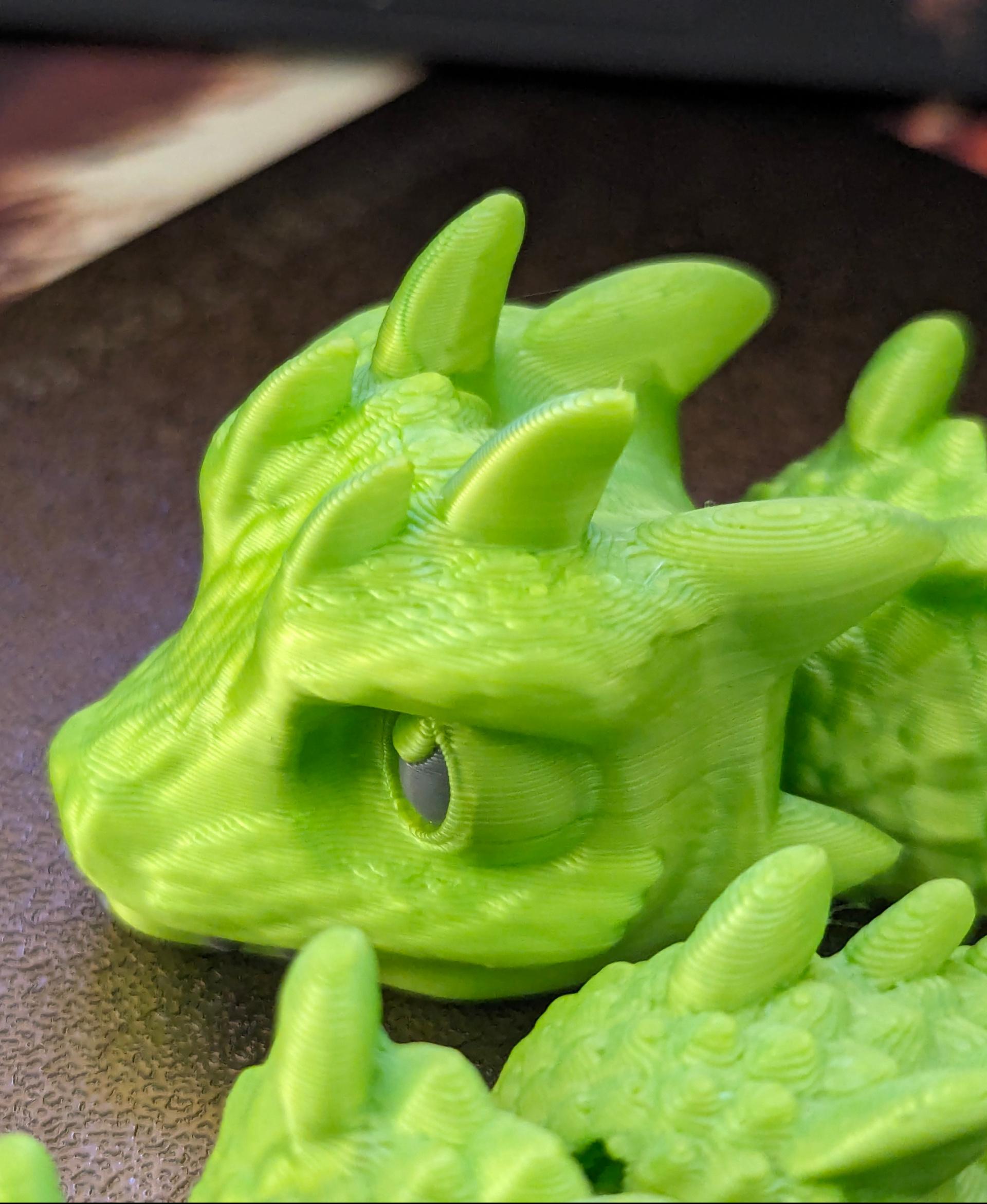 Baby Basilisk (Extra Long) - Articulated Snap-Flex Fidget (Medium Tightness Joints) - Printed on a Bambu Lab P1S, with Duramic 3D Silk PLA in neon green. Eyes and teeth are Duramic 3D PLA in smoke gray. - 3d model