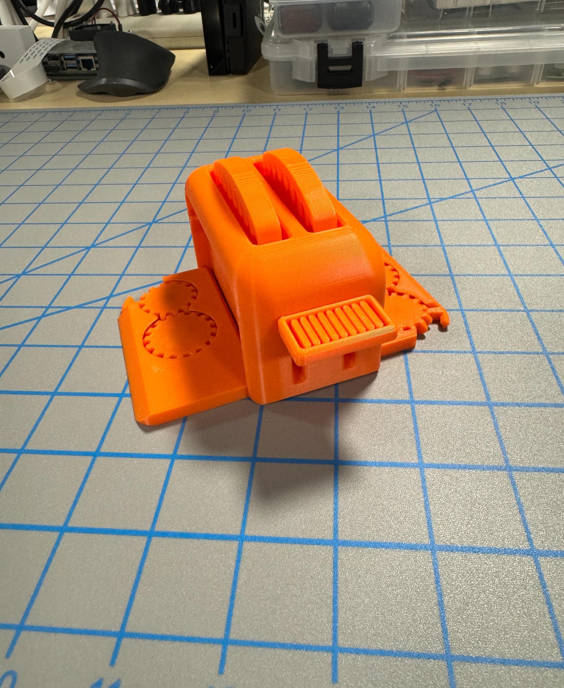 Clockspring3D Torture Toaster - Bambu P1S using Bambu standard orange PLA. All default settings, and it all works. - 3d model