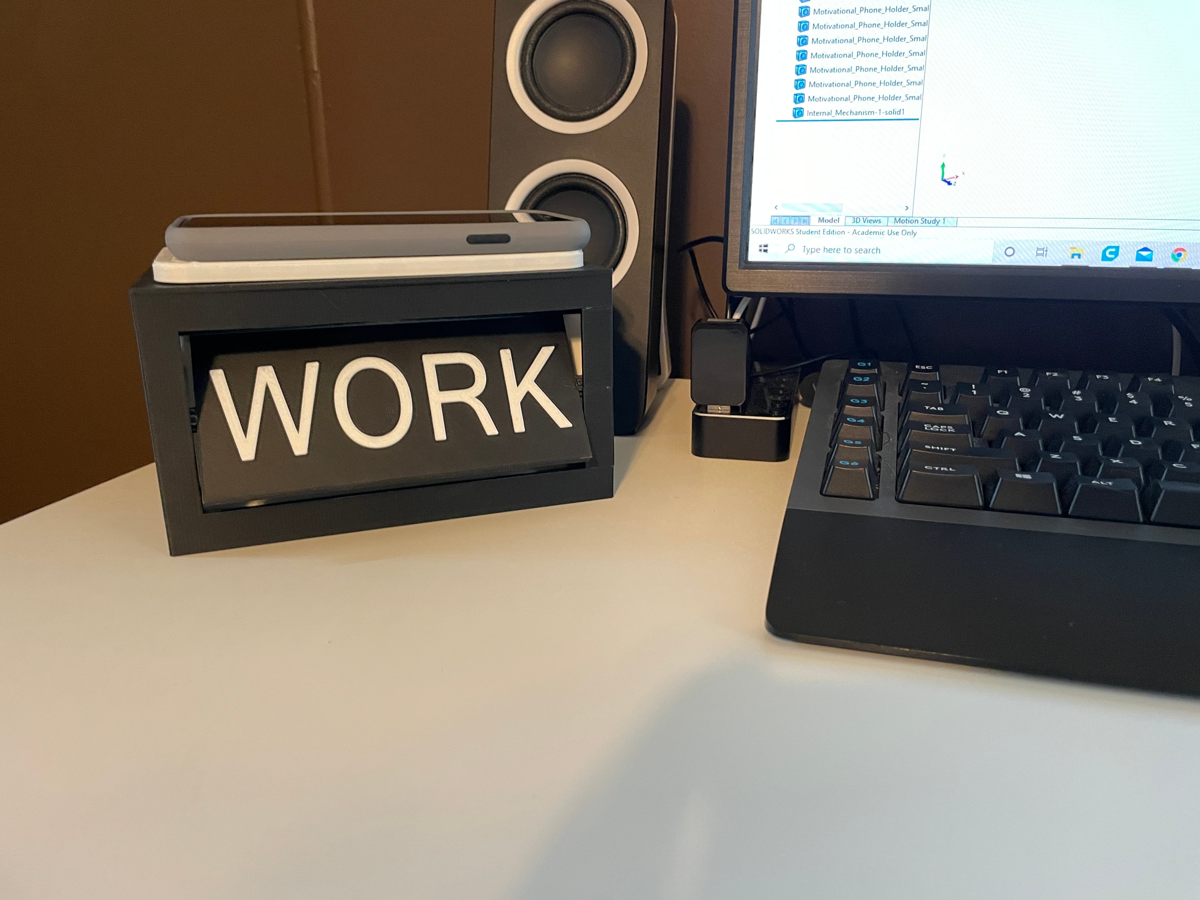 Motivational Phone Holder - Photo of it on a desk in action - 3d model