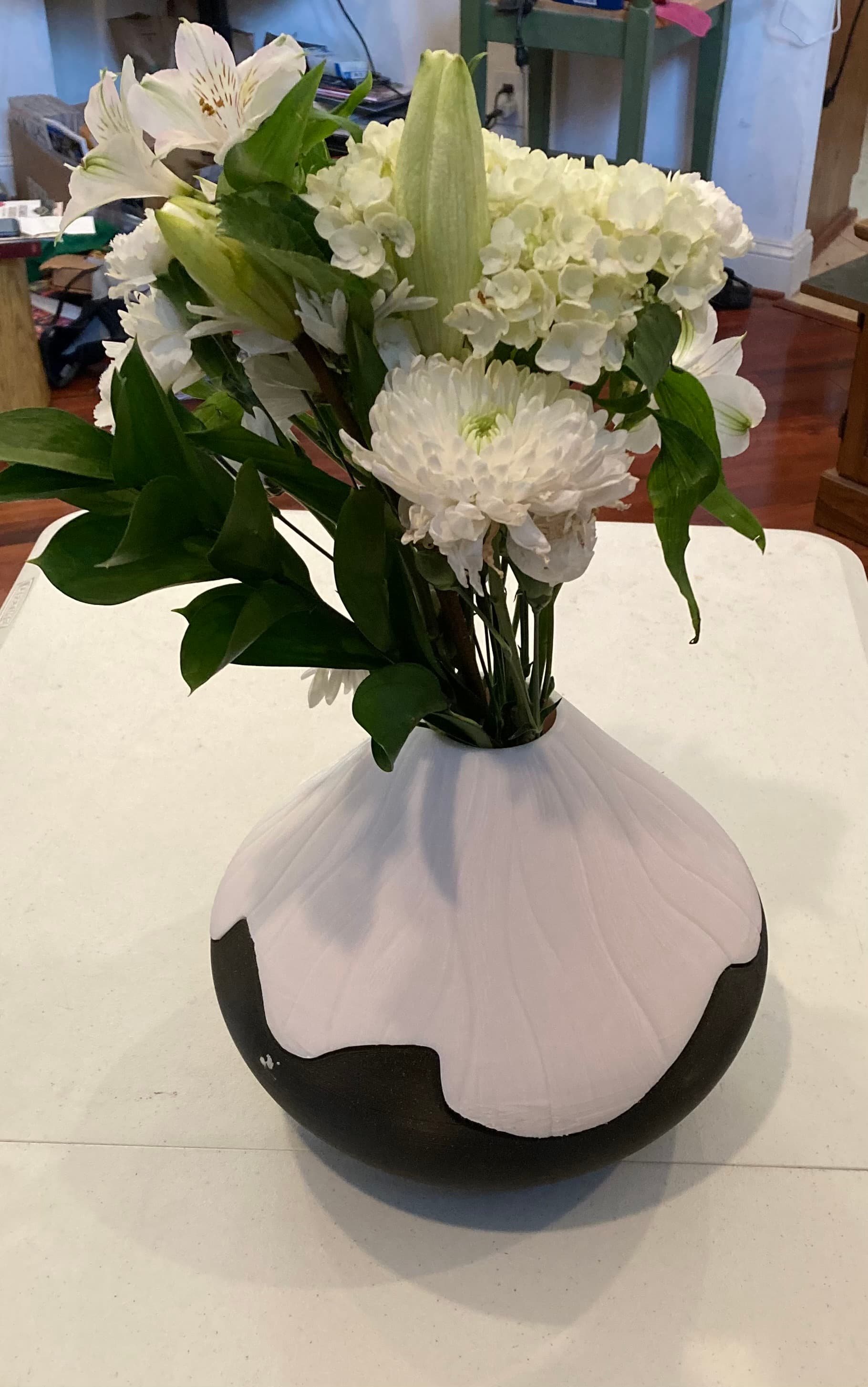 A lovely result after 42 hours printing. The flowers are real and not 3-D printed(!). The top half warped a bit at the transition between the supports and the first "real" layer for the design.