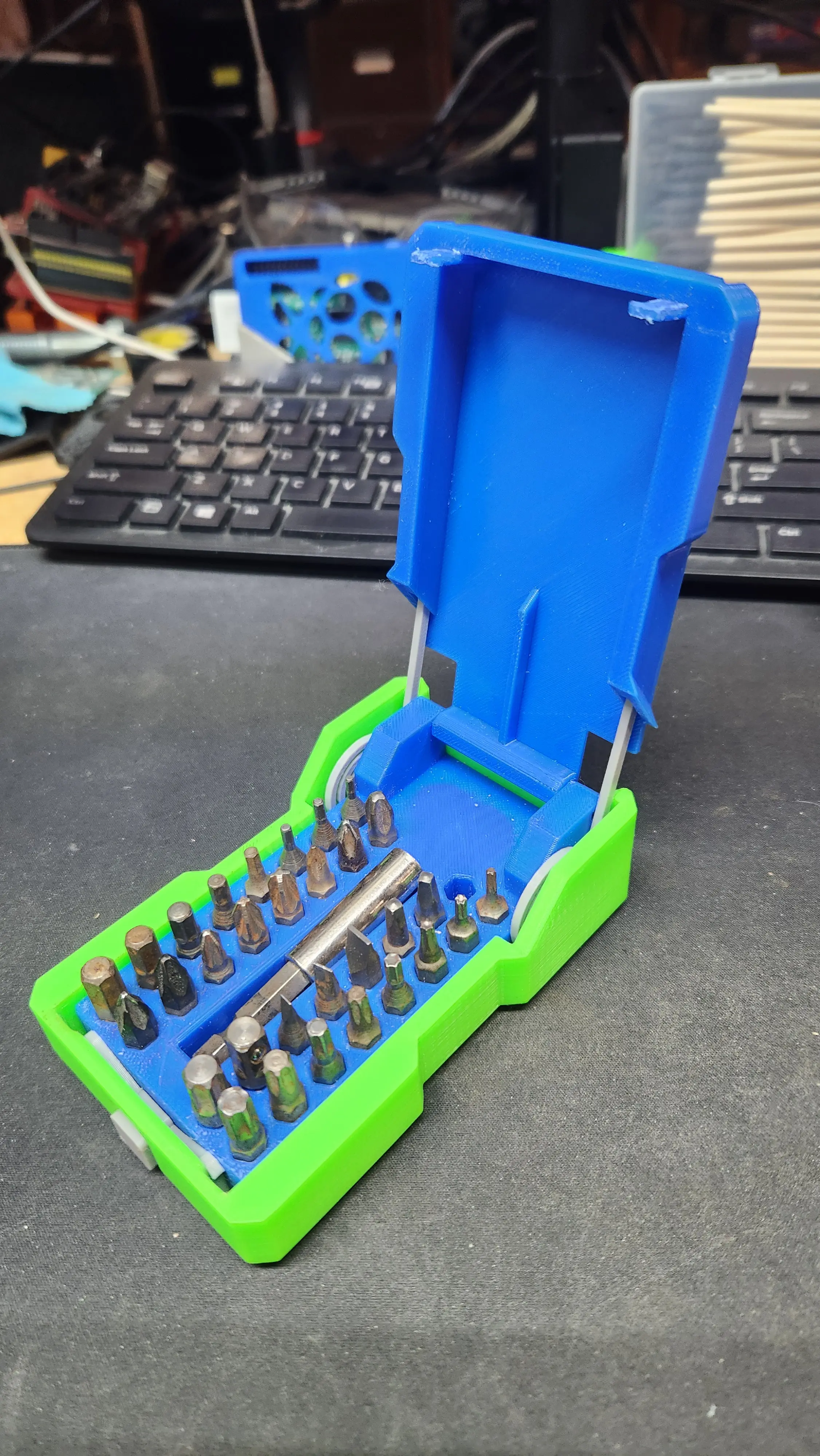Very cool design. I think wanting to check out the printed spring coils was the motivation I needed to finally organize the parts tray full of hex bits I've been digging through for several years, so thank you. I did make some minor modifications to the outer shell and release lock part to beef it up and eliminate twist in the mechanism, and added some small bumps inside the outer shell to help retain the container grid. very pleased with how it turned out.