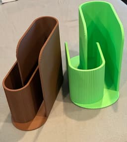 The original design printed well (brown) but the slots were too narrow for the folded notebook I have. I scaled the X-axis to make the design wider (green) and my unit now fits. 3d model