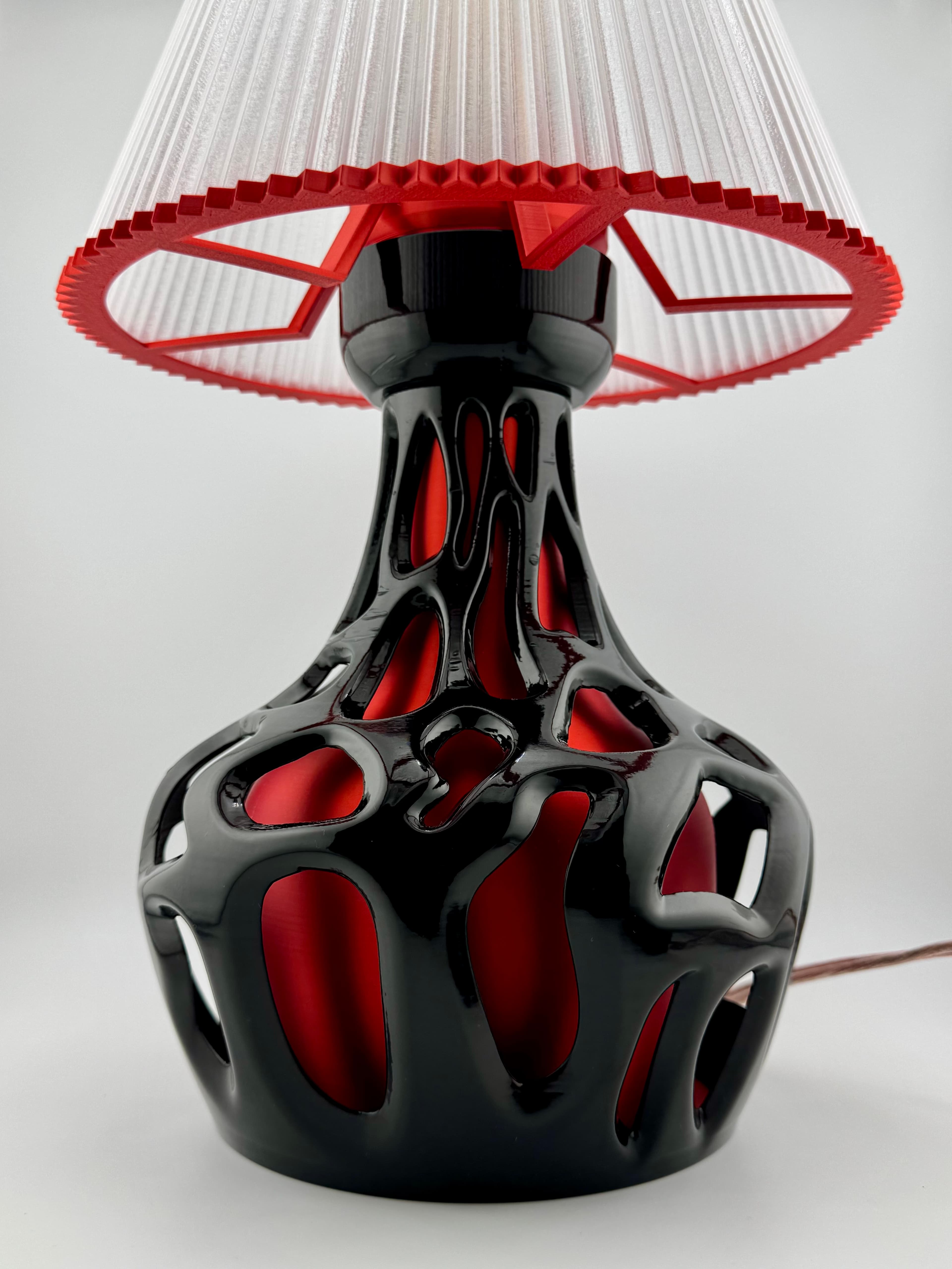 The base is made with PLA, the black part is finish with black gloss finish acrylic paint. The shade is made from translucent PETG from Bambu Lab.
