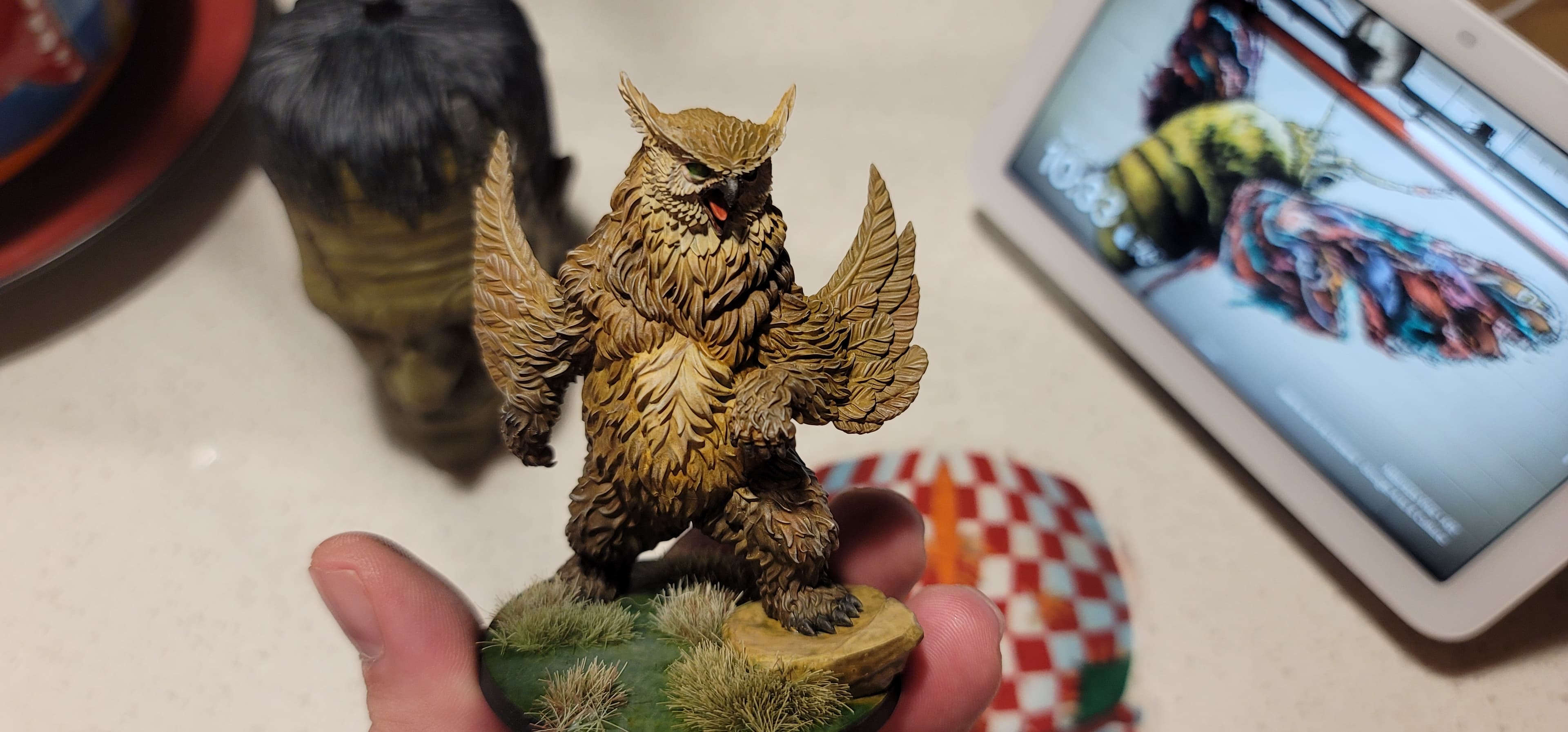 If I'm honest, I'm a bit proud of how this model came out. TF put together a very nicely detailed model. The included rock made basing and posing the model much easier. I pushed myself to work on layering techniques. I feel I did a good job on the body. By the time I got to the wings I was a bit burned out. In hindsight, I should have stopped for the evening and came back the next day. I spent about 4 hours in total on this guy. The owlbear was printed on an Elegoo Mars 5 Ultra in a combination of gray resins that I had available; probably a mix of Elegoo ABS-like and 8K.
It is painted with Vallejo model and game color paints. No washes or shades were used on the figure. I applied Citadel Athonian Camoshade to the rock for definition and a moss-weathered look. The base was covered in a Citadel Agrellan Earth Technical paint and covered with Citadel Mantis Warriors Green Contrast paint. I added some grass tufts I picked up from the local gaming shop to complete the base.