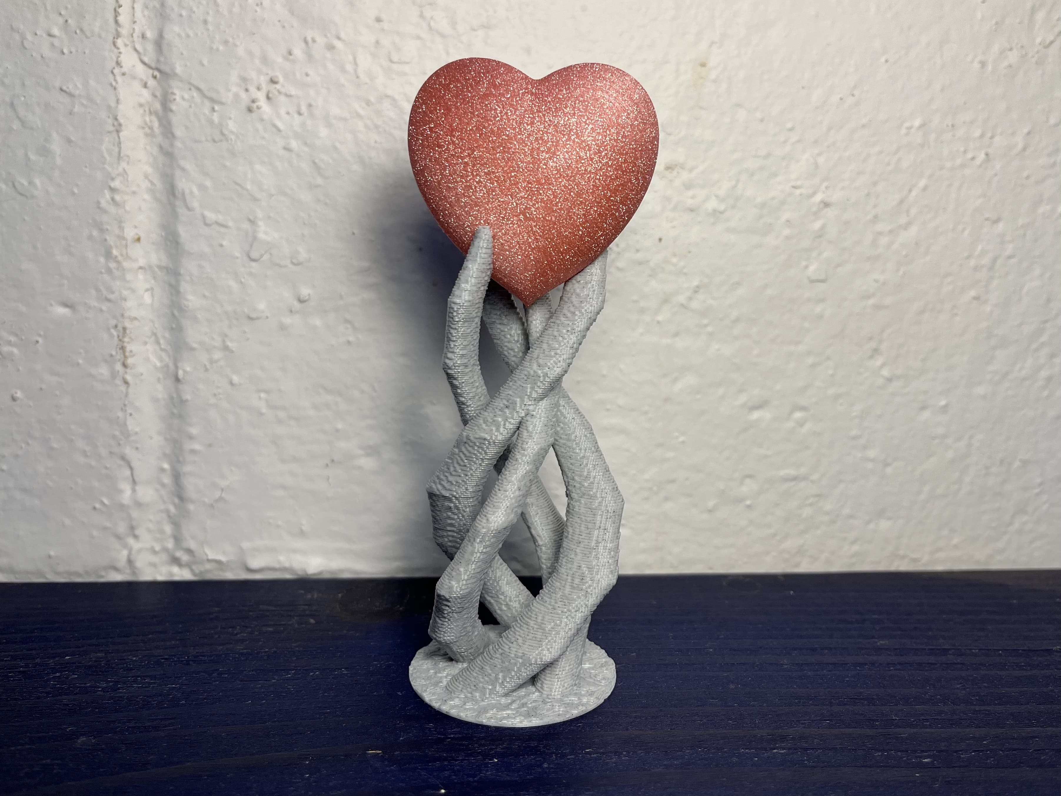Alien3D Particle Pink PLA Heart with Polyalchemy Granite FX PLA base. Base at 0.25mm Draft settings in PrusaSlicer on Prusa Mini. Heart printed with variable layer height going from 0.25mm at the back to 0.05mm at the front. Printed laying down with supports because this filament really shines while looking down onto the layers. It also hides the layer lines so well that I probably didn't even need to go so detailed, but it took the same amount of time as a constant 0.1mm layer height part that was printed standing up.