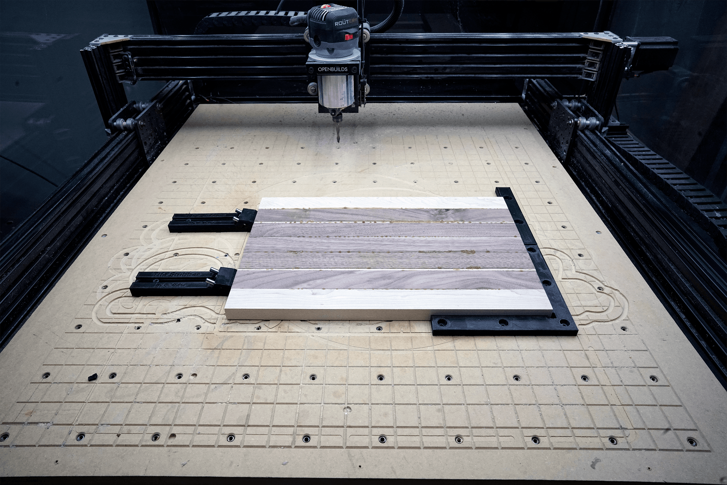 Low Profile Toe Clamp for CNC Router (Heat-Set Insert Version) - This cutting board if firmly held by two toe clamps pressing the board into the right-angle jig. The entire top of the cutting board can be faced/carved without running over a clamp. - 3d model