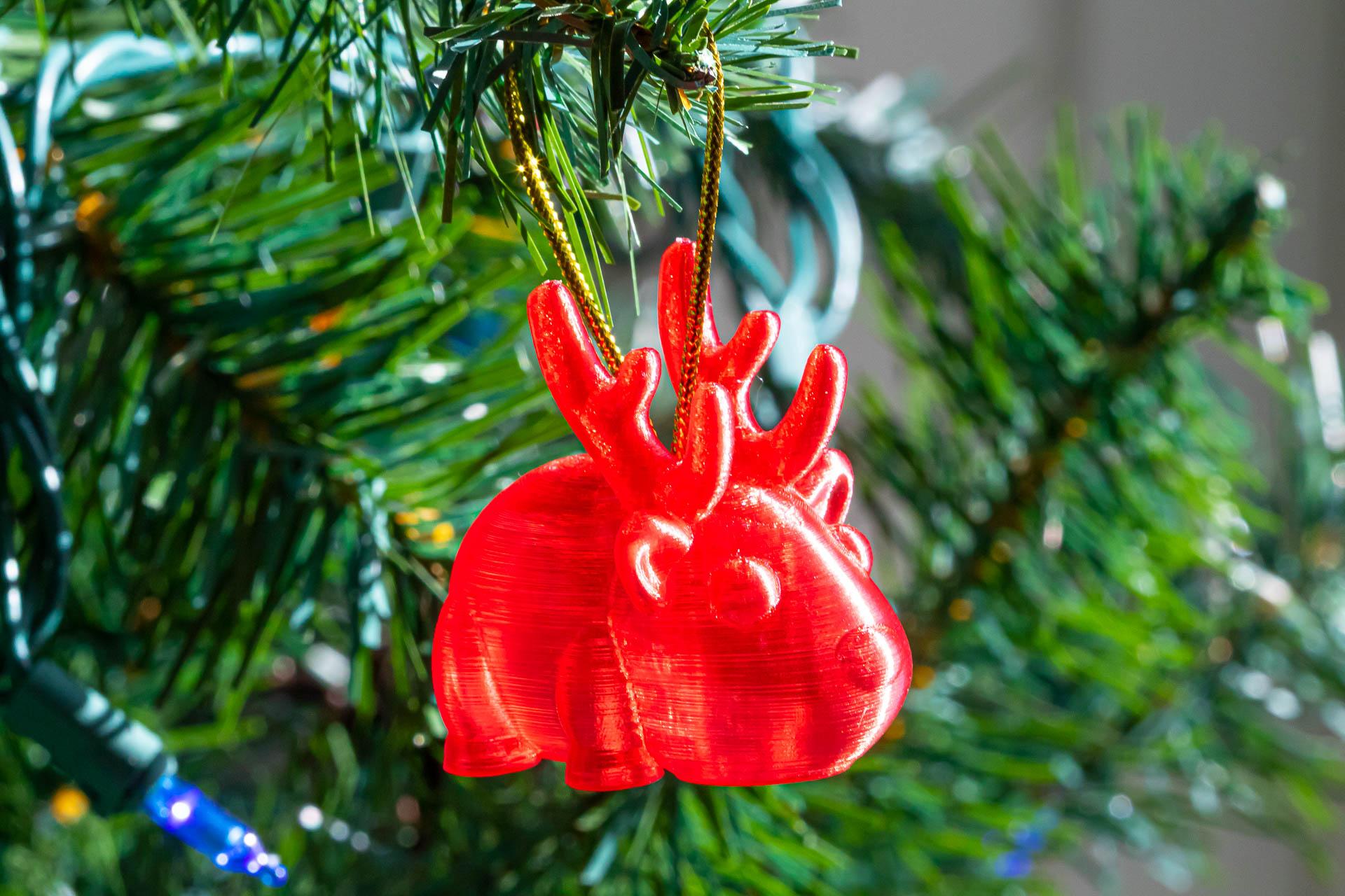 Small Reindeer Ornament - A huge thanks to BuildOverBot for posting this wonderful design! It printed beautifully on the first try and only took about 40 minutes to print.

Printed using Matterhackers Translucent Red PLA.

Walls are 1 line thick (0.4 mm) to maximize transparency. 

Layers are 0.15 mm.

I repurposed the gold thread from a set of package labels. - 3d model