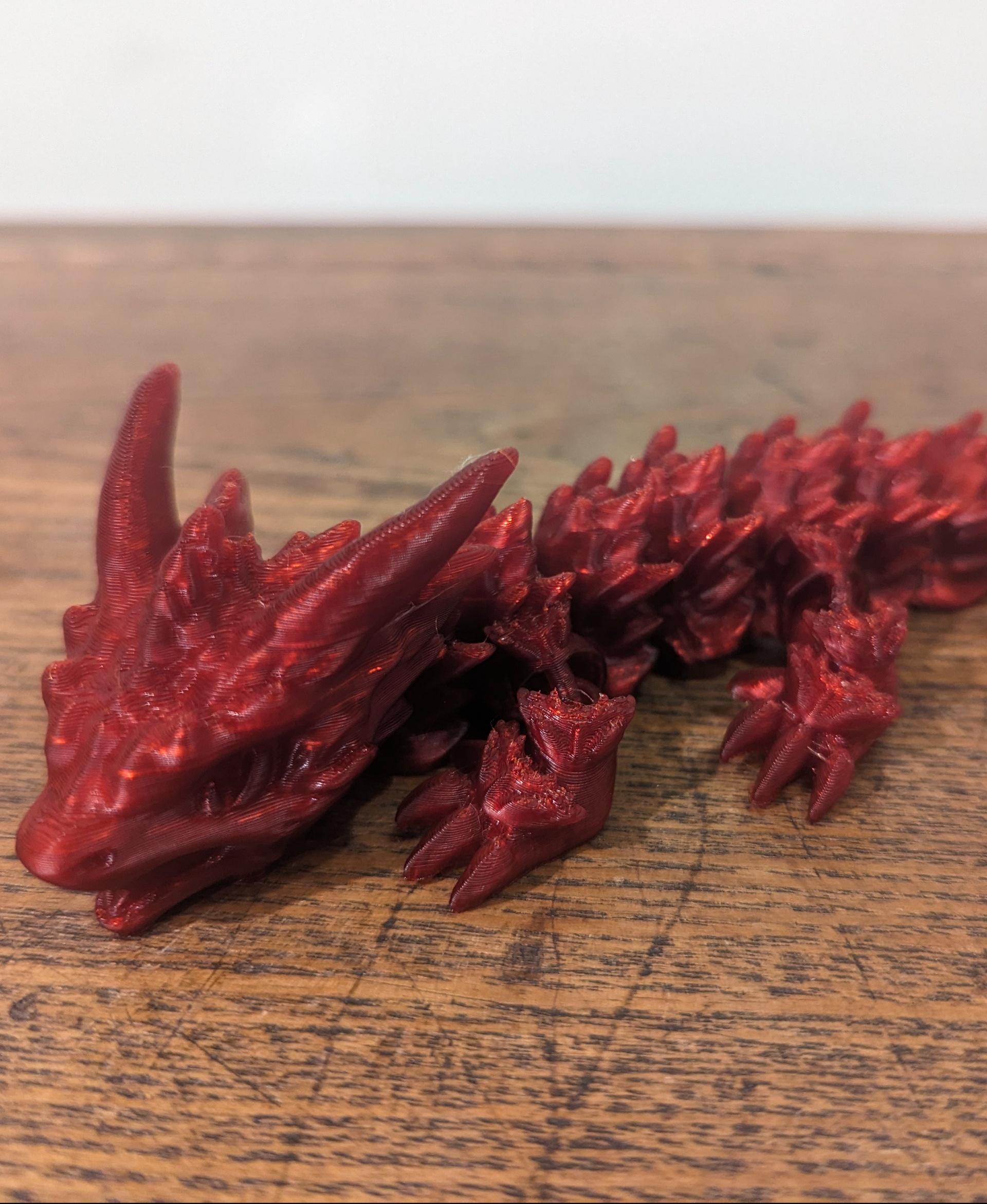 Frostbite, Winter Dragon Child - Articulated Snap-Flex Fidget (Medium Tightness Joints) - FrostBite printed on the KP3S in Coex3D Translucent Blood Red - 3d model